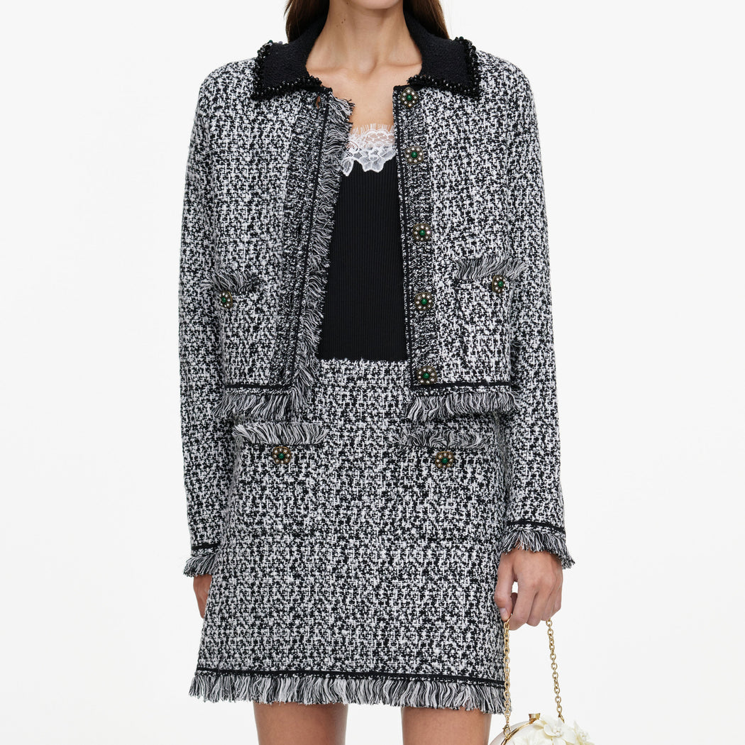 A close up of a woman wearing the Black And White Textured Knit Jacket