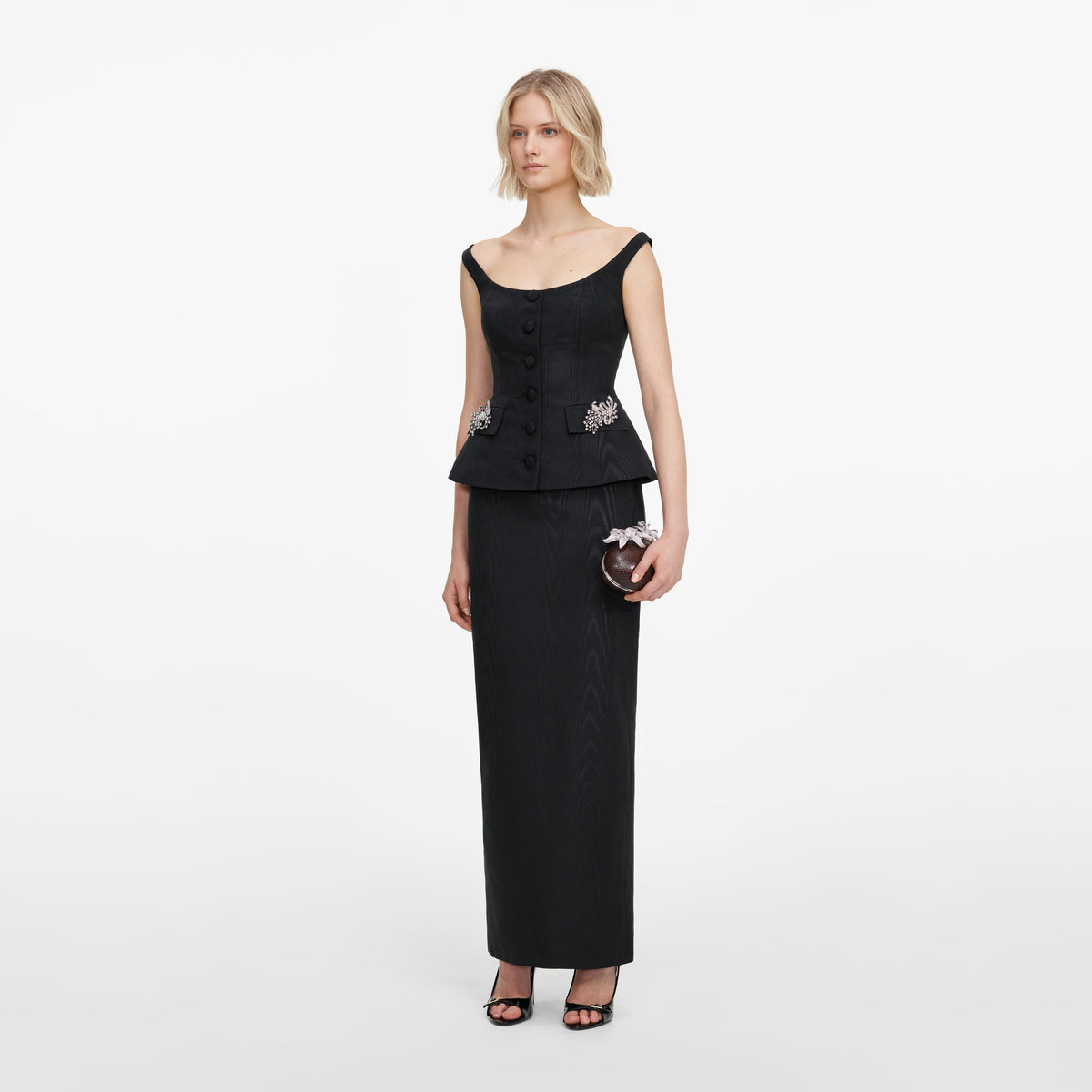 Side view of a woman wearing the Black Structured Bardot Maxi Dress