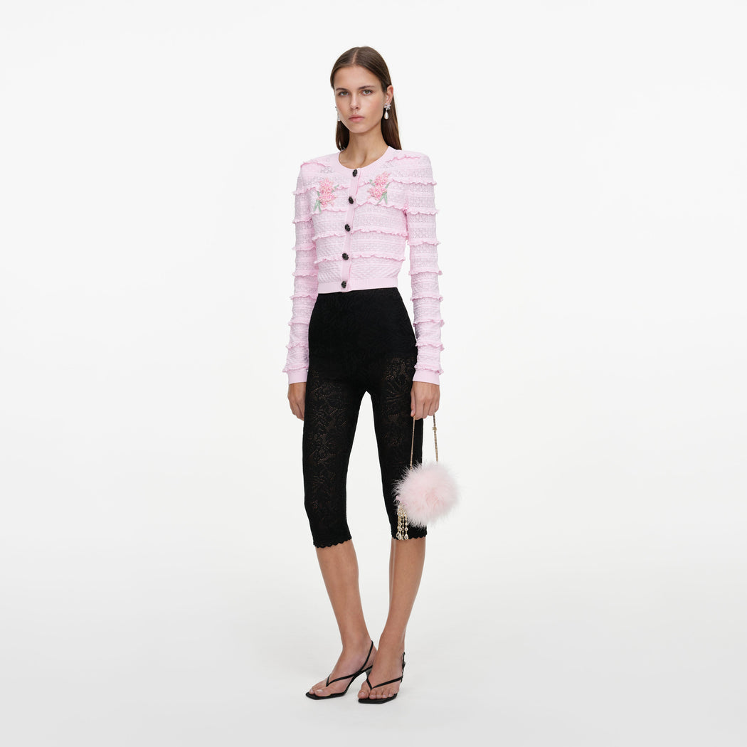 Side view of a woman wearing the Pink Flower Pointelle Knit Cardigan