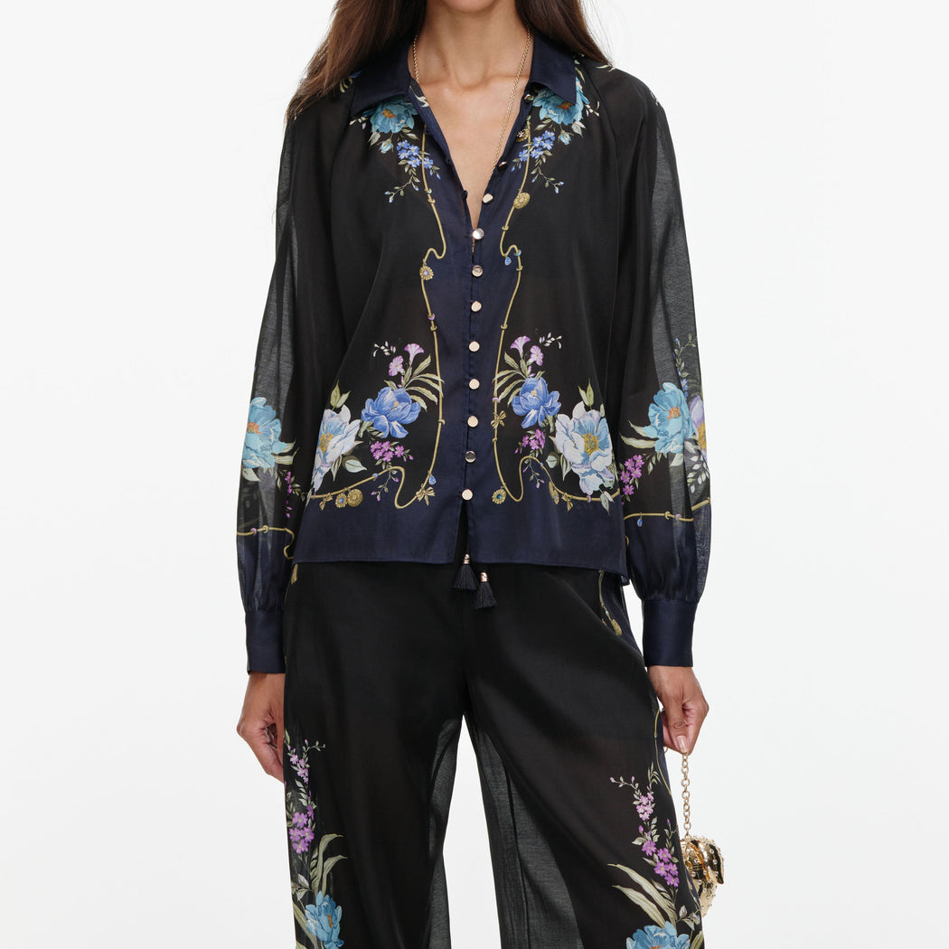 A close up of a woman wearing the Navy Floral Organza Trousers