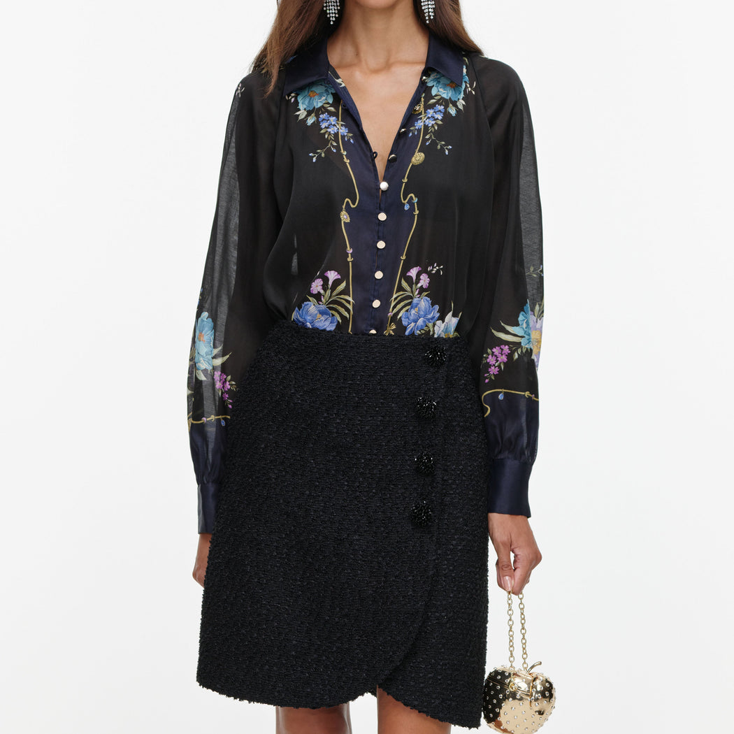 A close up of a woman wearing the Navy Floral Organza Blouse