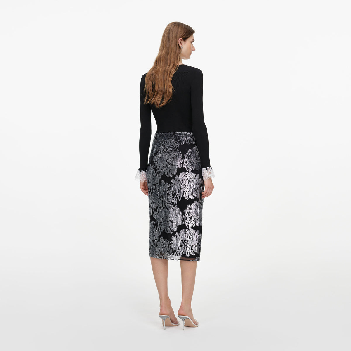 Back view of a woman wearing the Silver Fil Coupe Midi Skirt