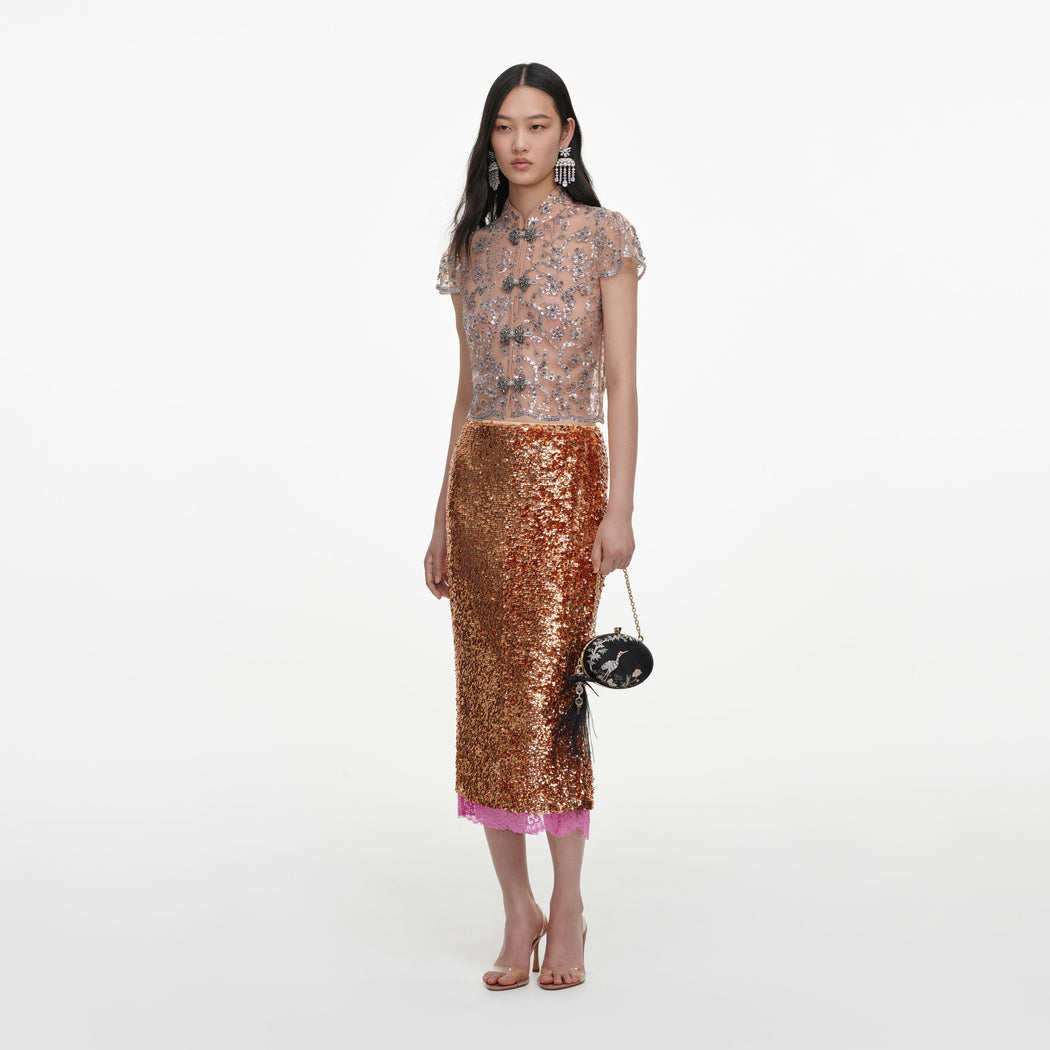 Side view of a woman wearing the Silver Sequin Embellished Top