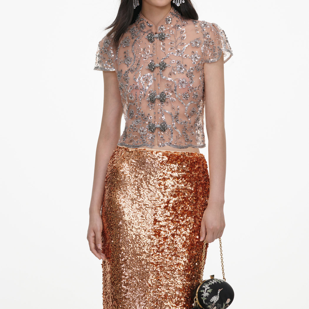 A close up of a woman wearing the Silver Sequin Embellished Top
