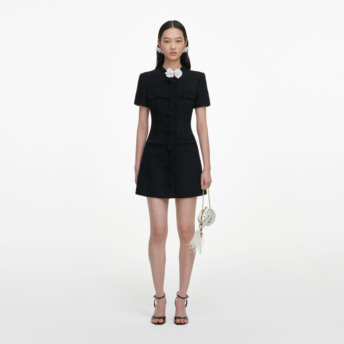 Front view of a woman wearing the Black Boucle Flower Mini Dress