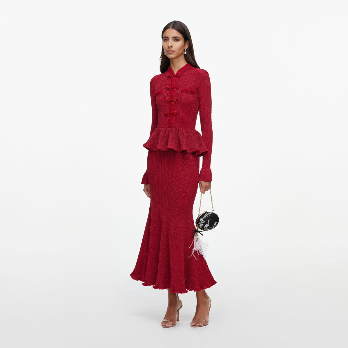 Side view of a woman wearing the Red Metallic Peplum Knit Midi Dress
