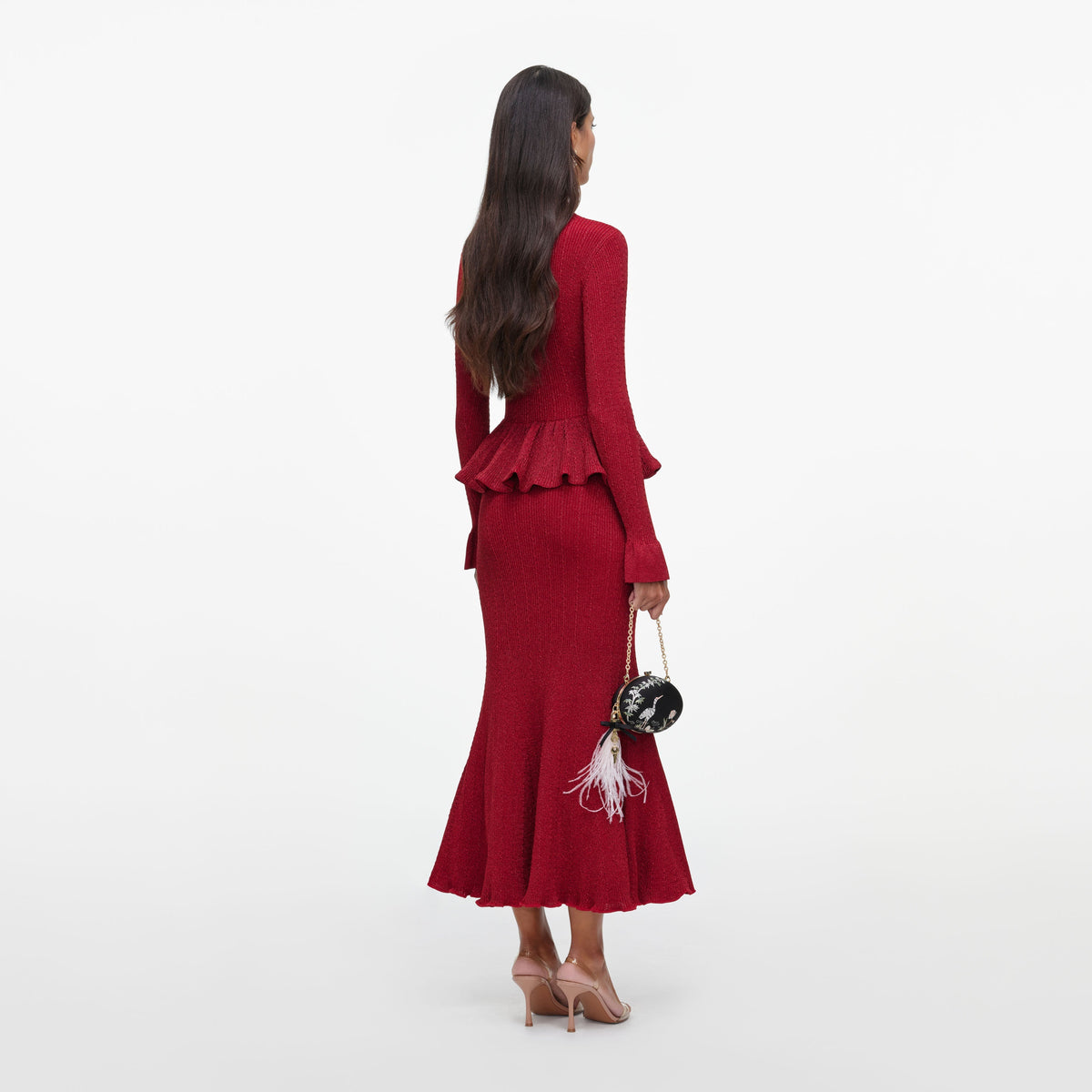 Back view of a woman wearing the Red Metallic Peplum Knit Midi Dress