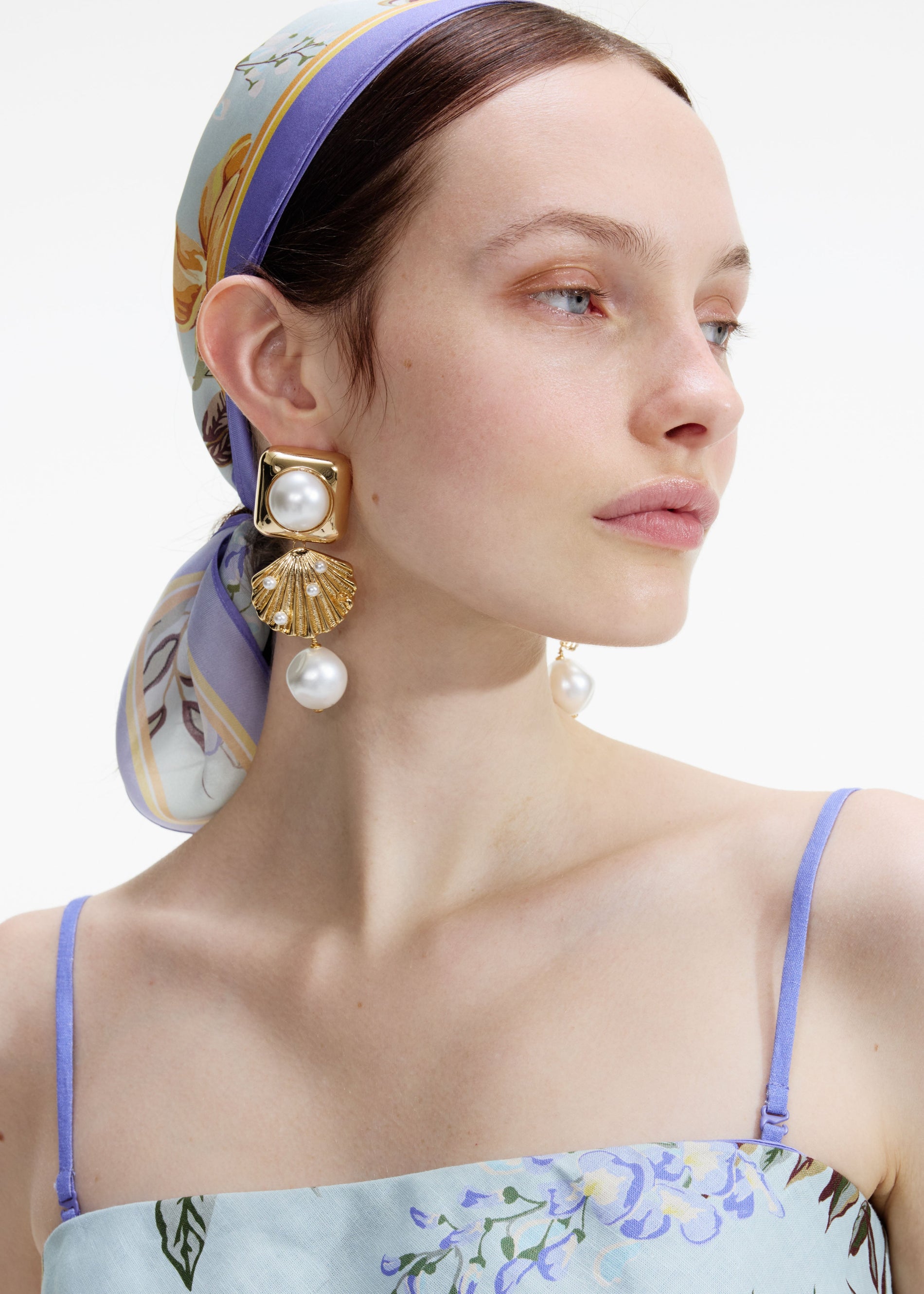 A photo of the Gold Pearl Shell Earrings