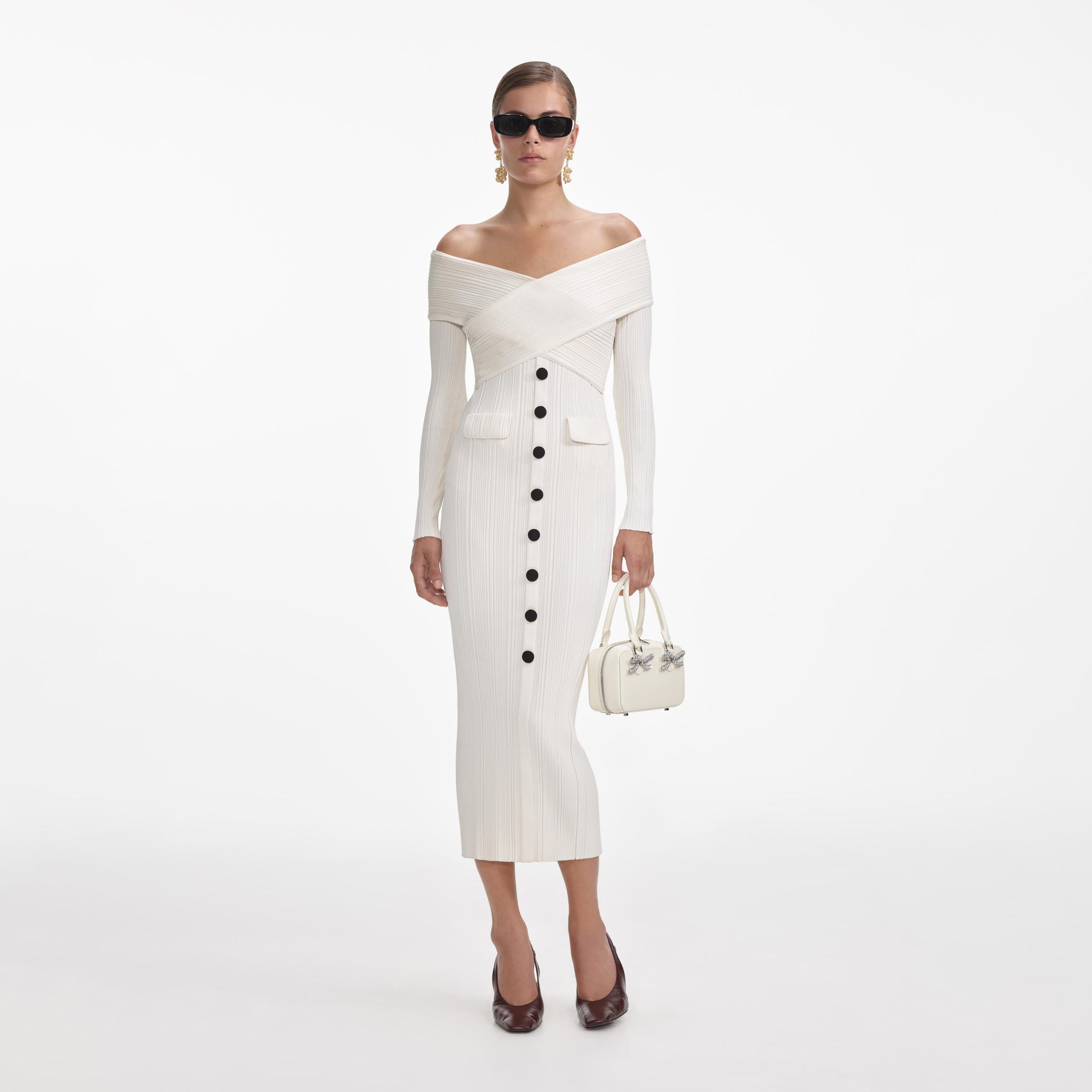 Front view of a woman wearing the Cream Off Shoulder Knit Midi Dress