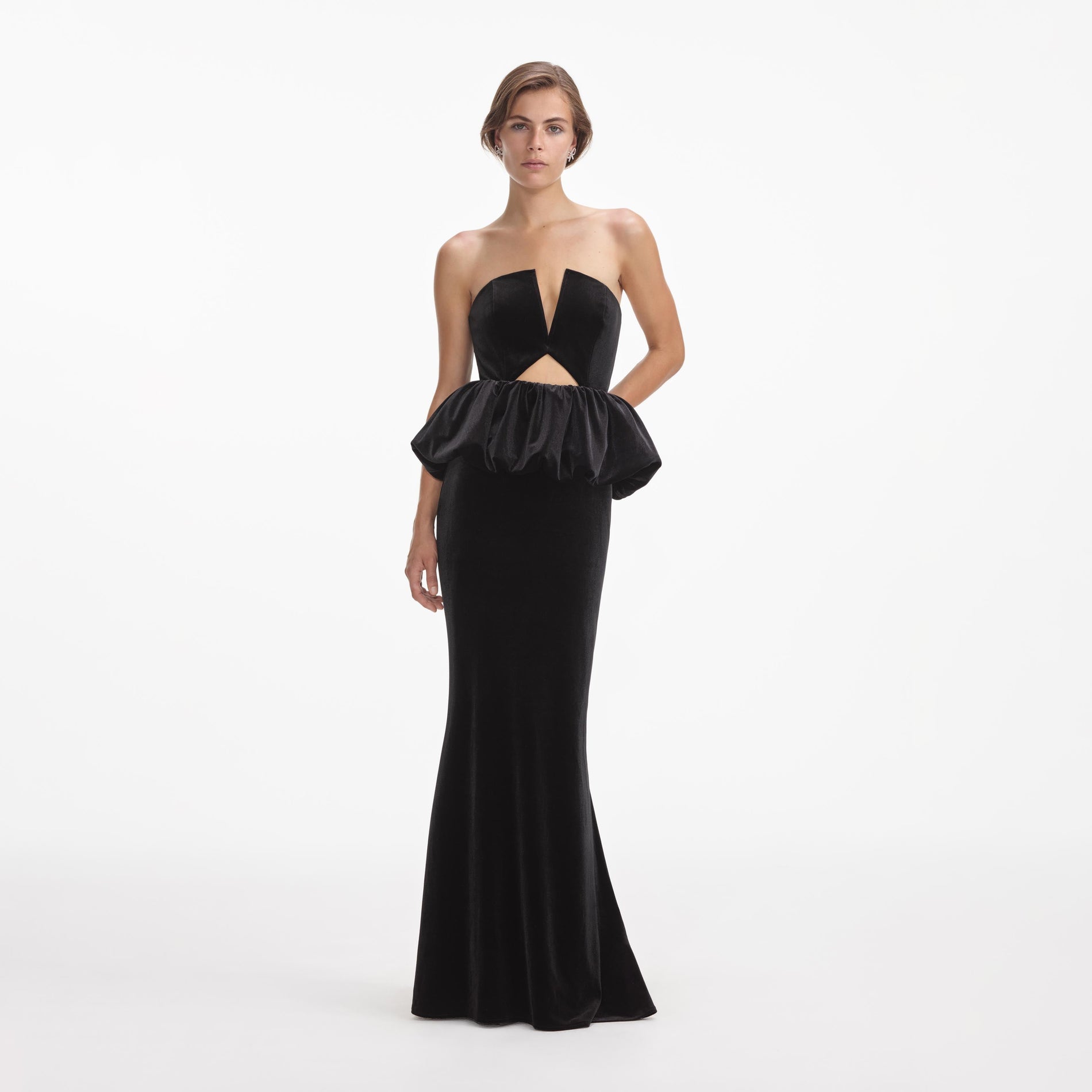 Front view of a woman wearing the Black Velvet Peplum Maxi Dress