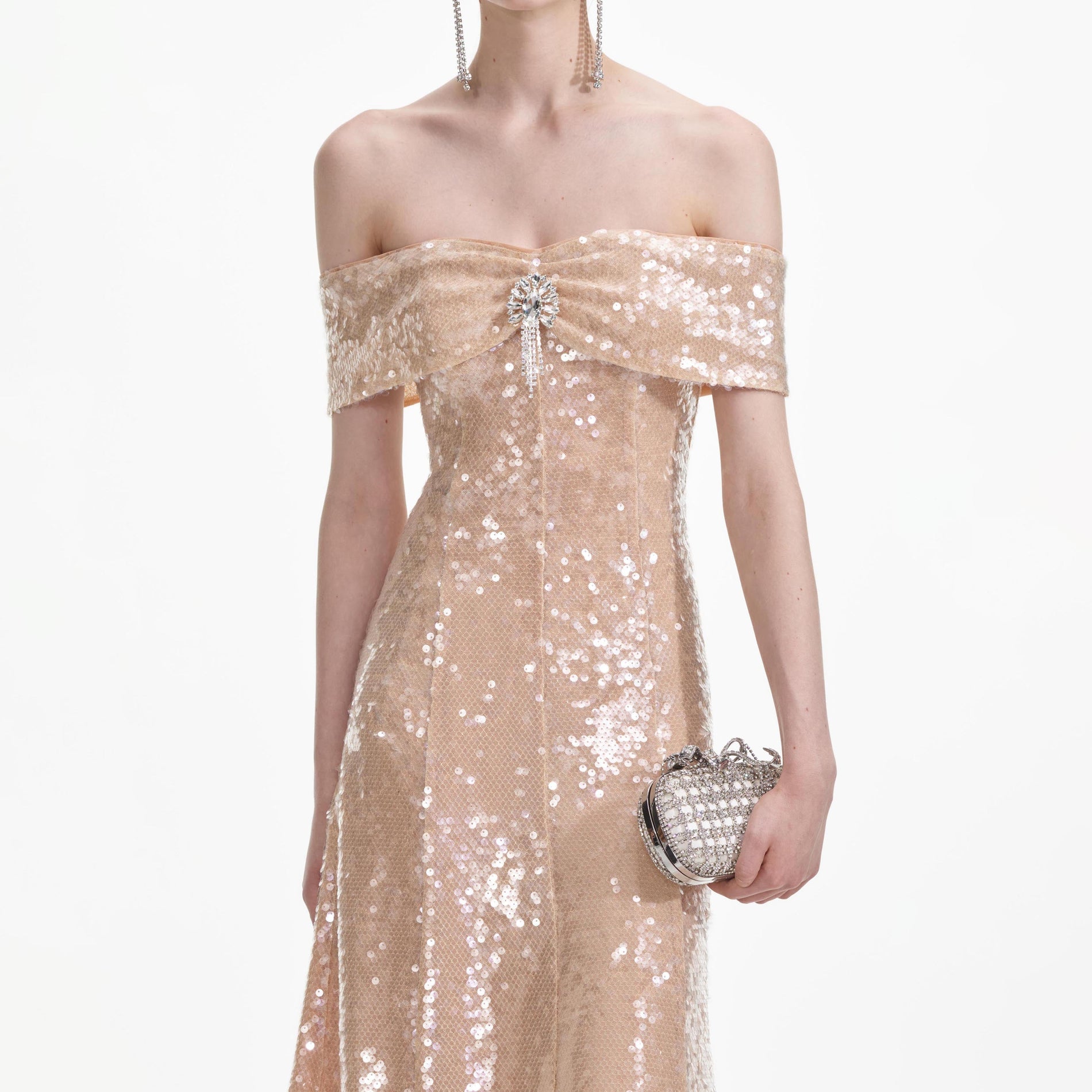 A close up of a woman wearing the Gold Sequin Off Shoulder Midi Dress