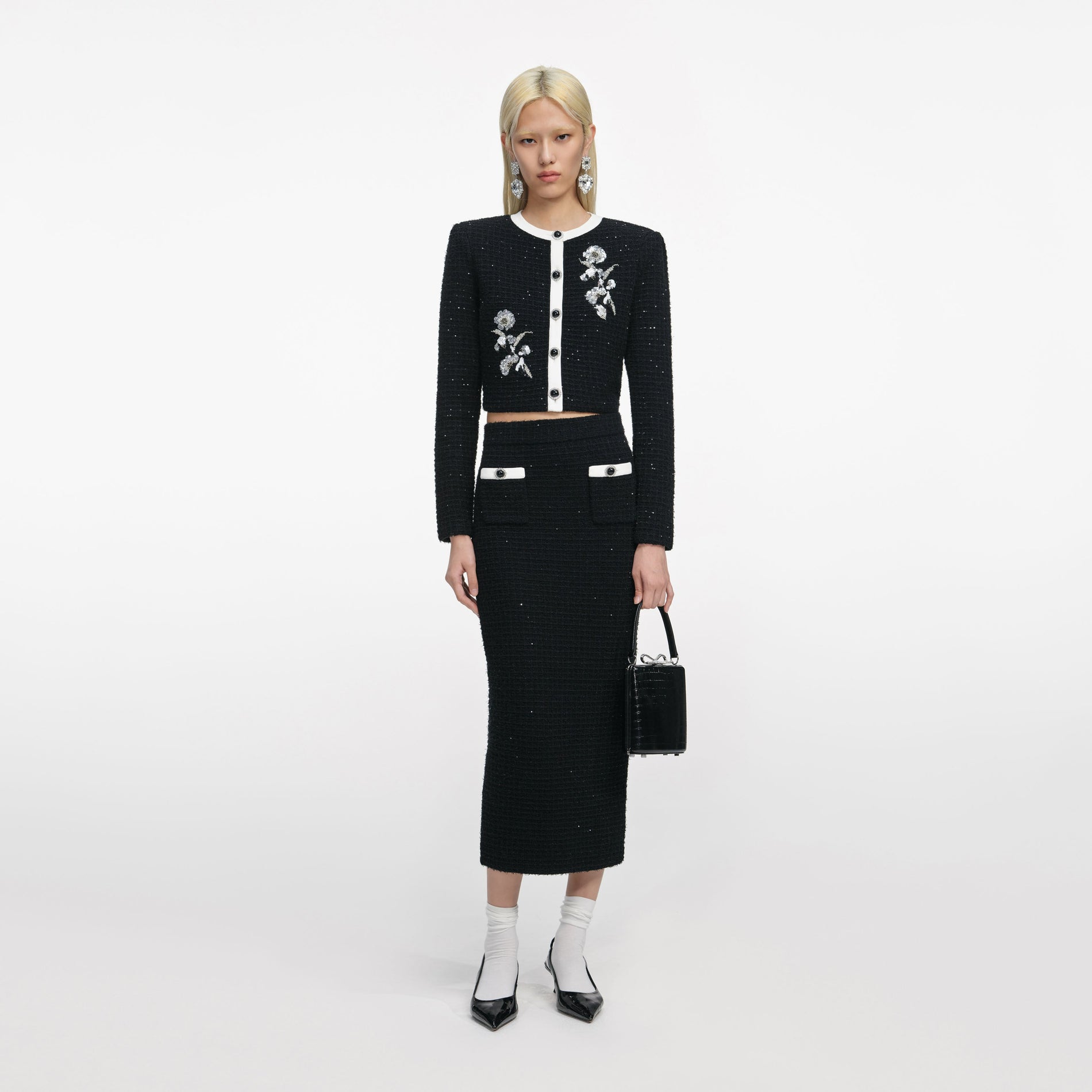 Front view of a woman wearing the Black Floral Textured Knit Jacket