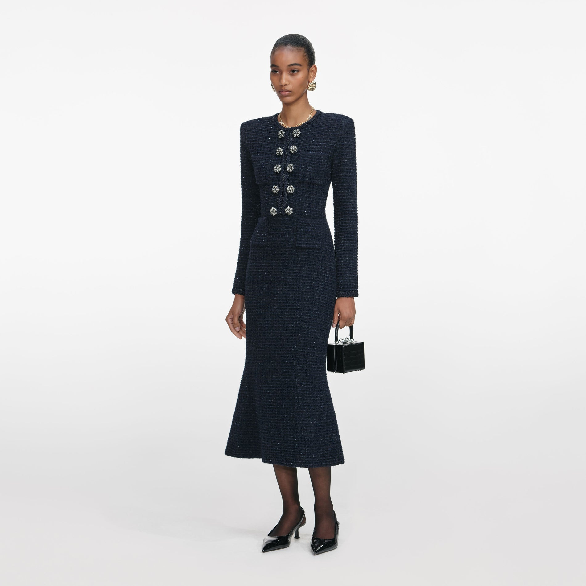 Side view of a woman wearing the Navy Textured Knit Midi Dress