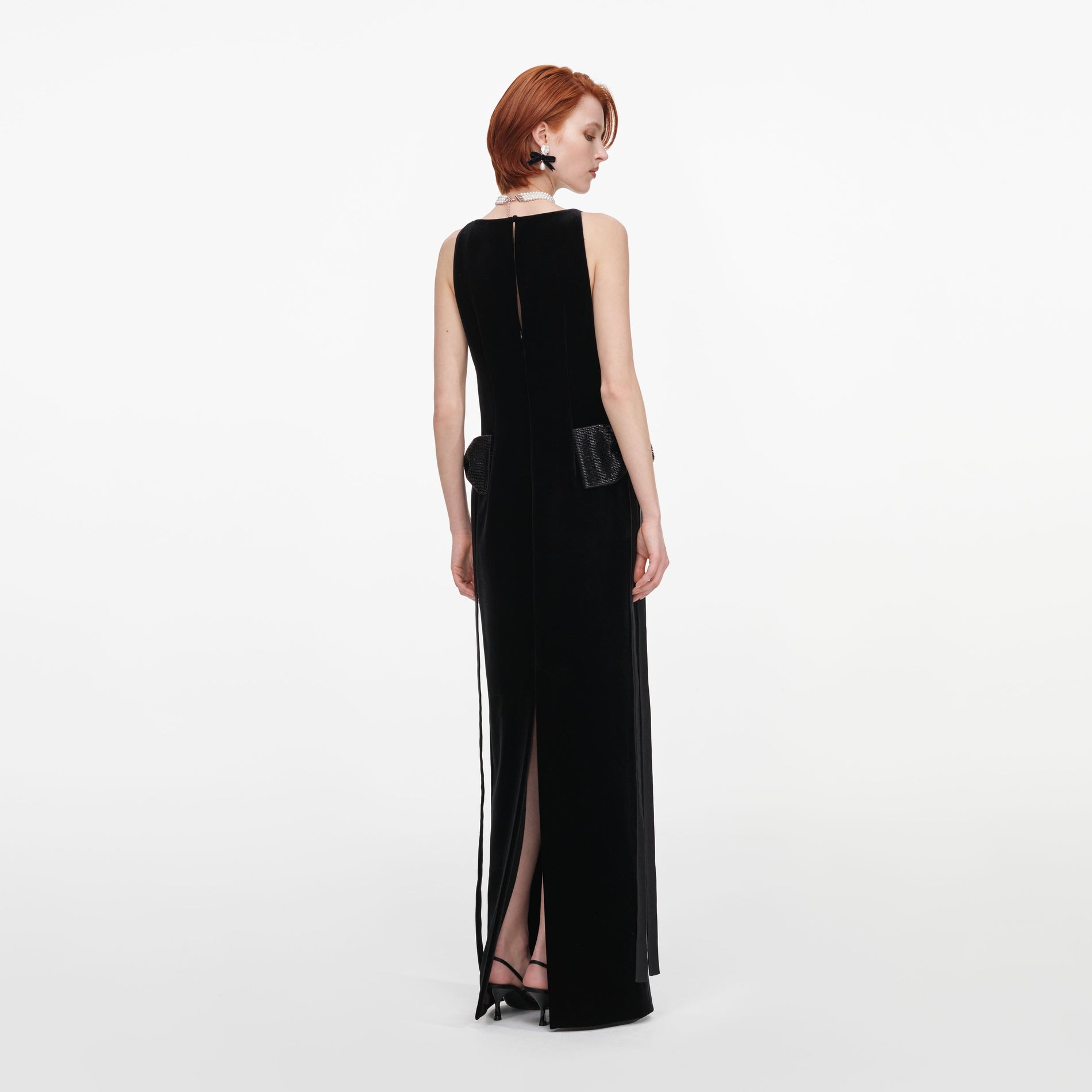 Back view of a woman wearing the Black Velvet Bow Sides Maxi Dress