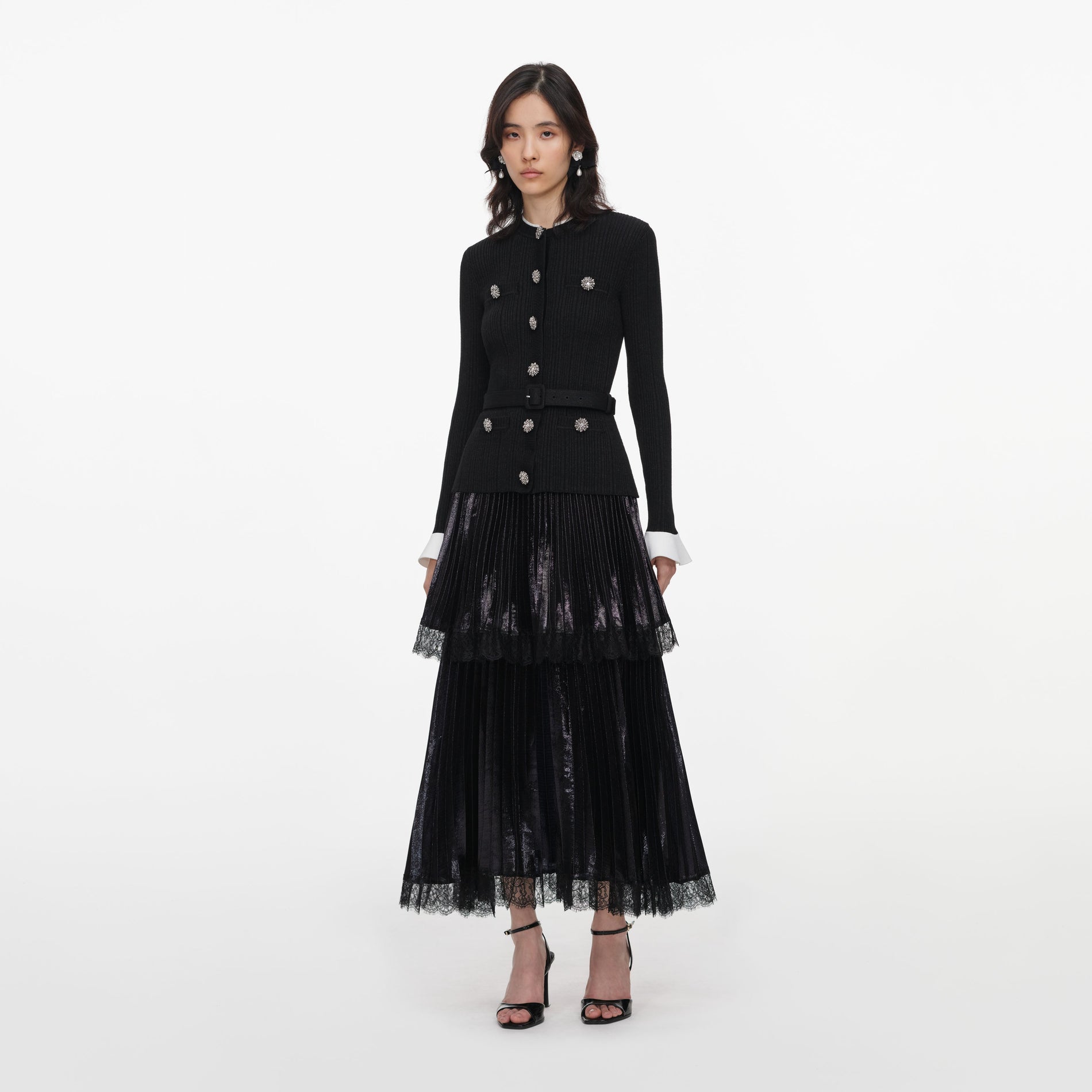Side view of a woman wearing the Black Knit Metallic Chiffon Midi Dress