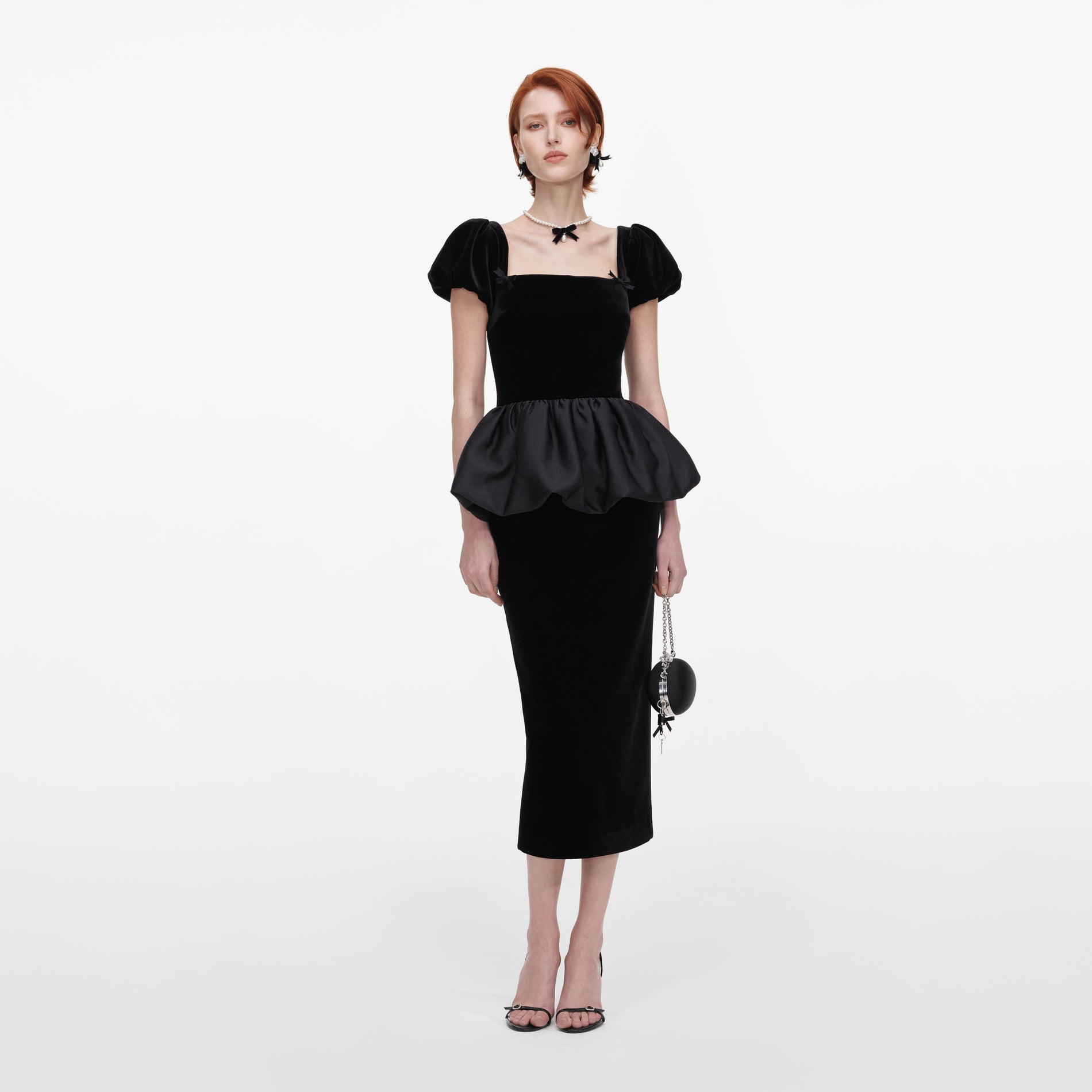 Front view of a woman wearing the Black Velvet Bubble Peplum Midi Dress