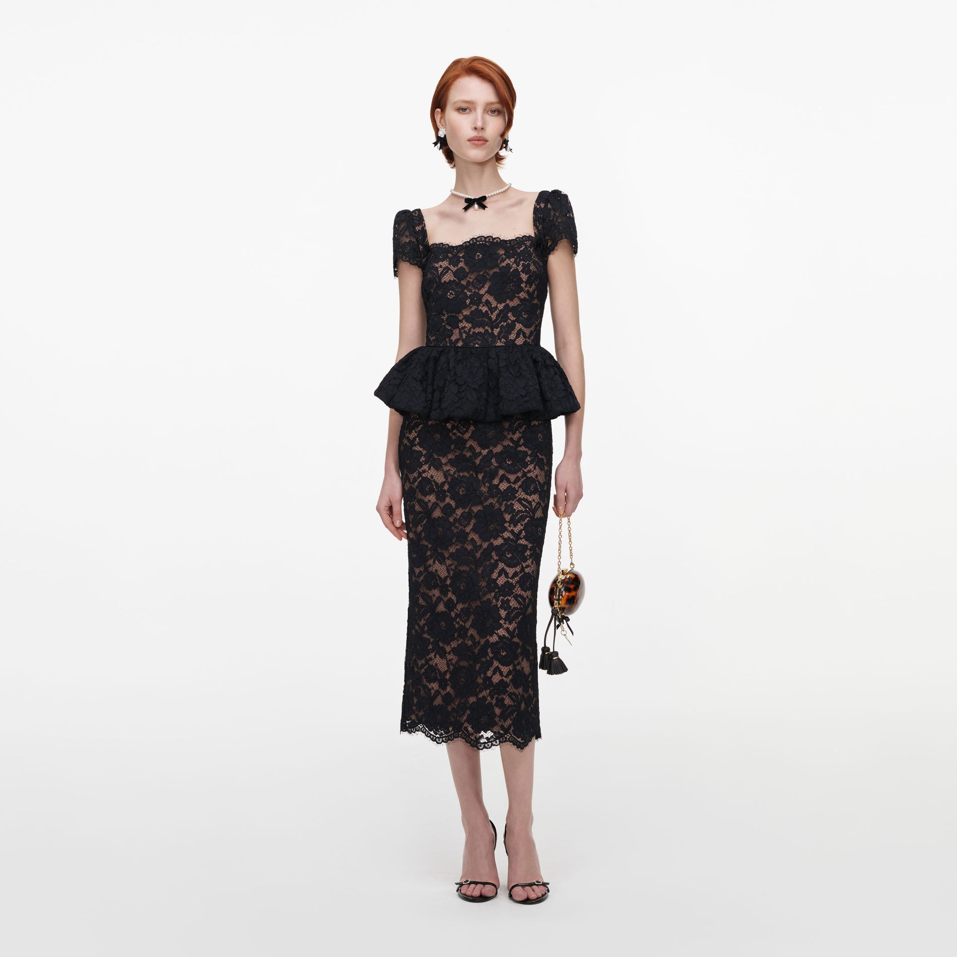 Front view of a woman wearing the Black Fine Lace Peplum Midi Dress