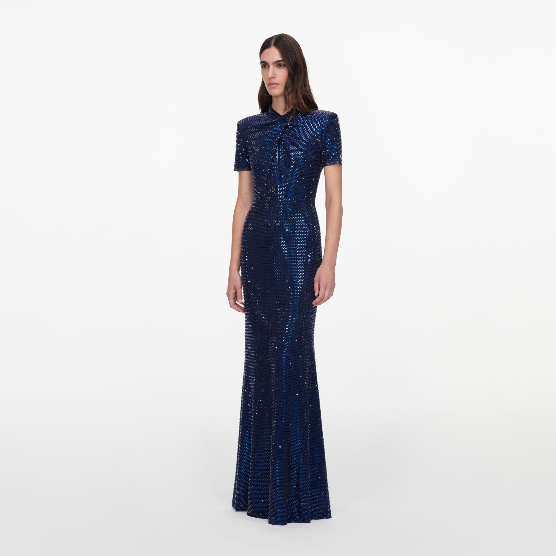 Side view of a woman wearing the Navy Rhinestone Mesh Twist Maxi Dress