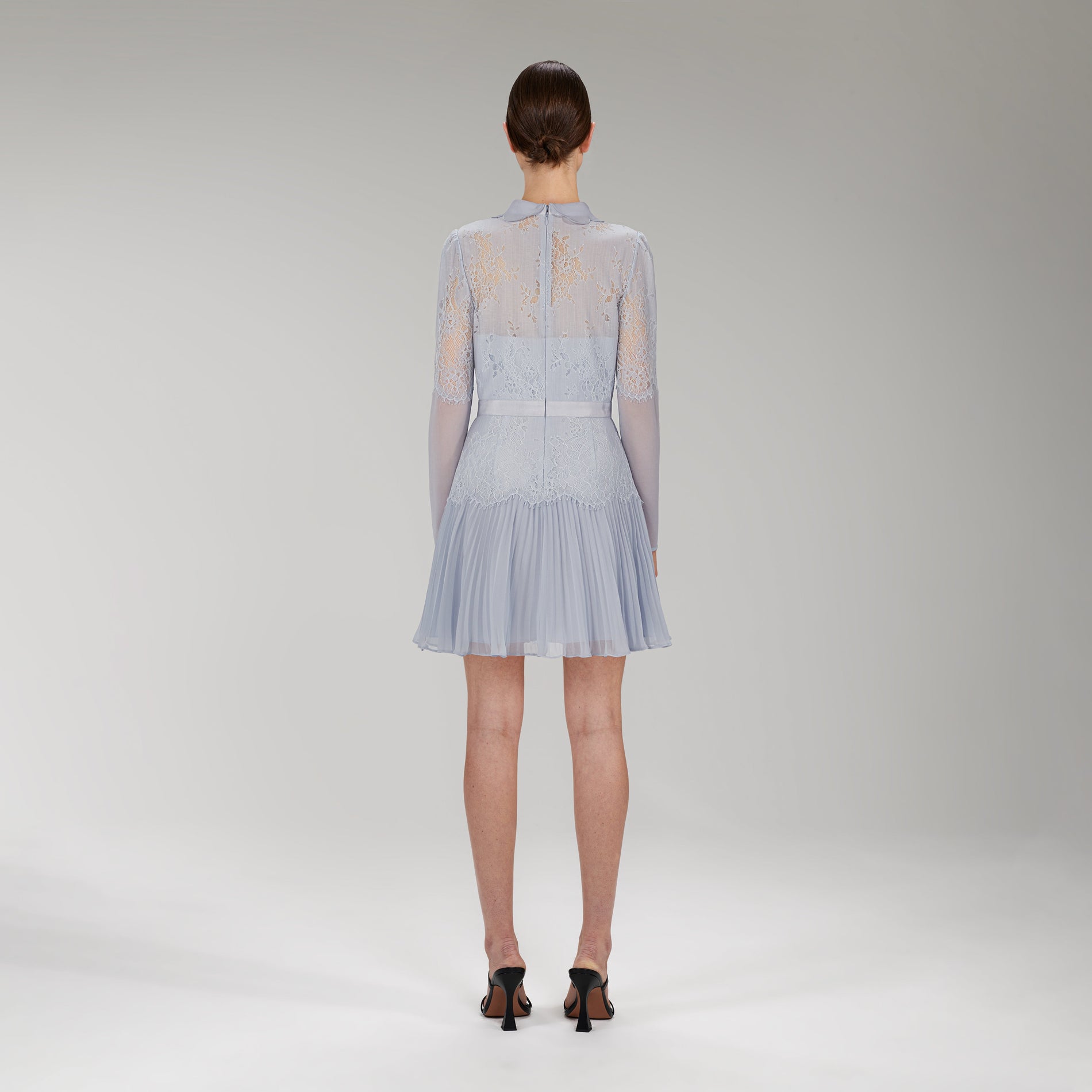 Back view of a woman wearing the Light Blue Lace Panel Mini Dress