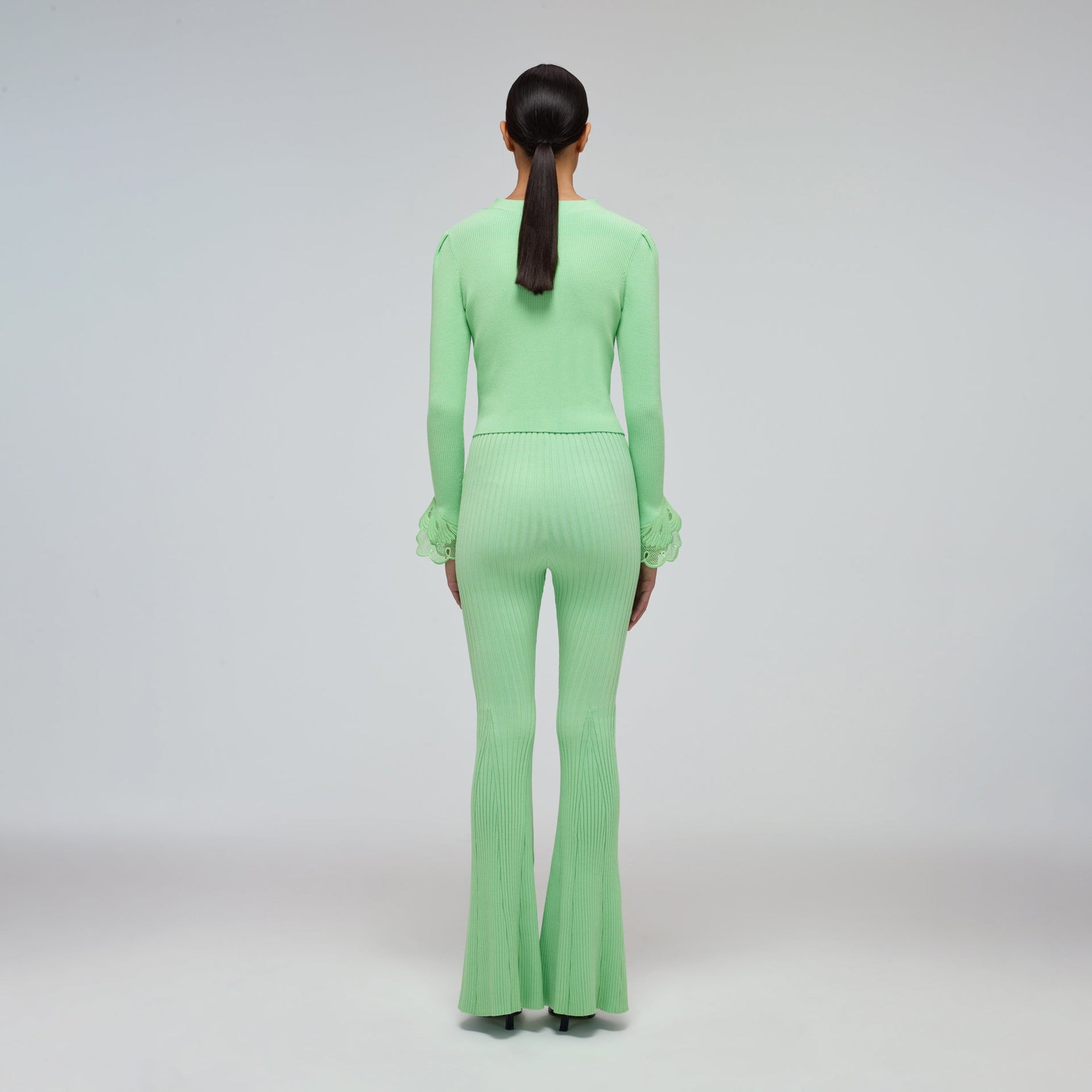 A woman wearing the Spearmint Ribbed Knit Trouser