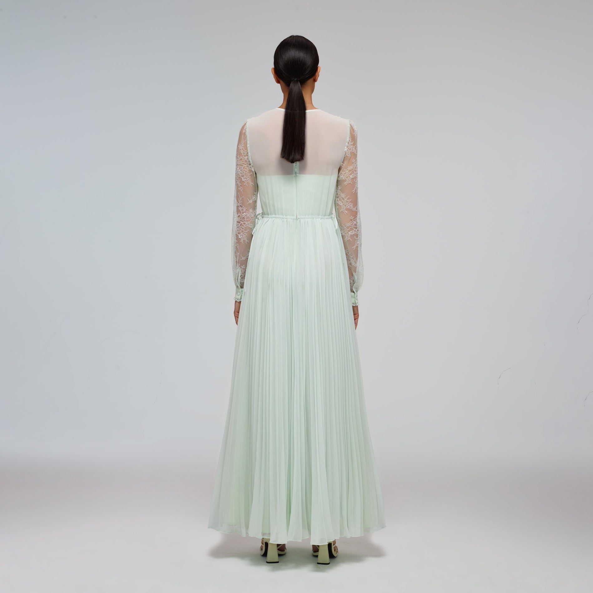 A woman wearing the Mint Chiffon & Fine Lace Maxi Dress