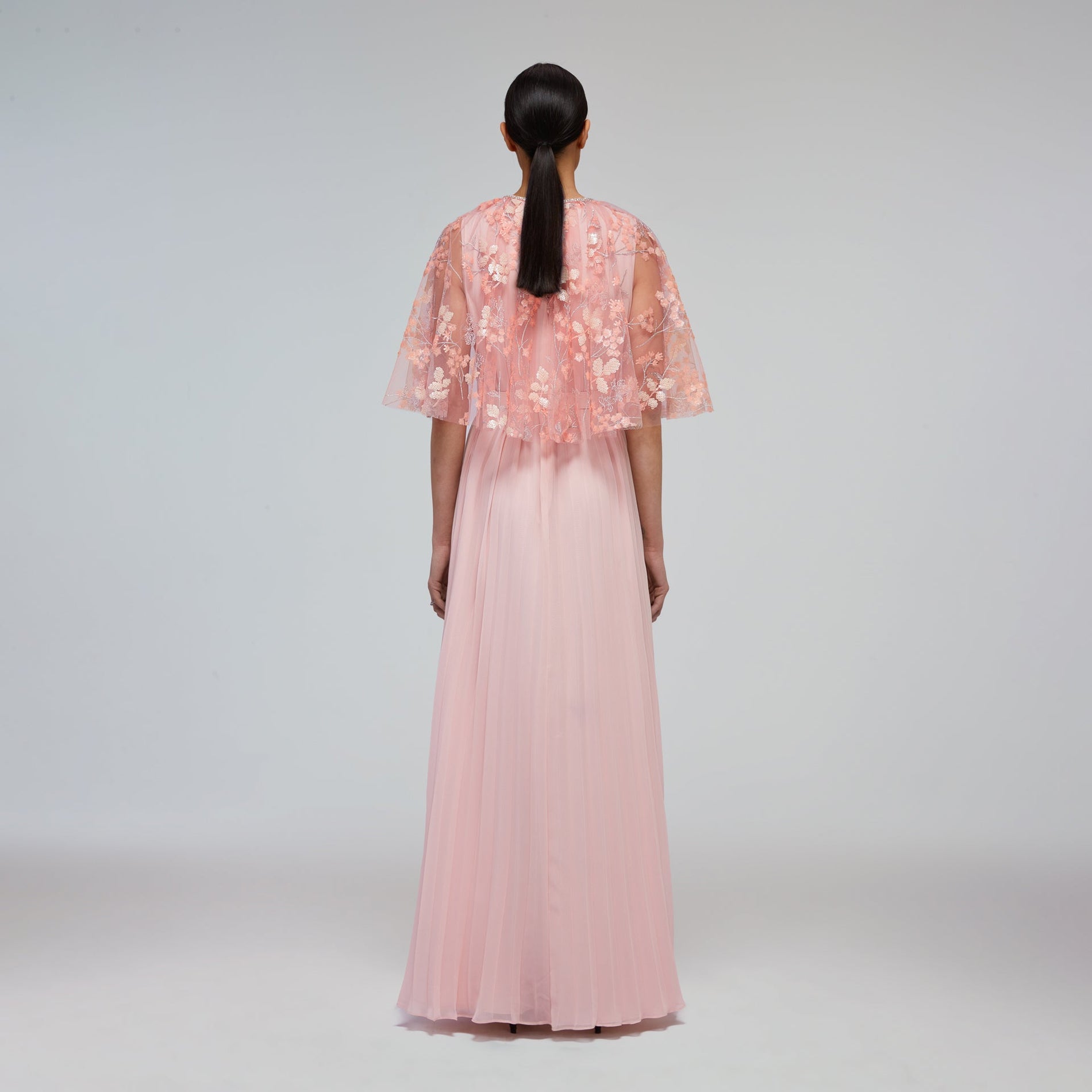 A woman wearing the Blossom Sequin Chiffon Maxi Dress