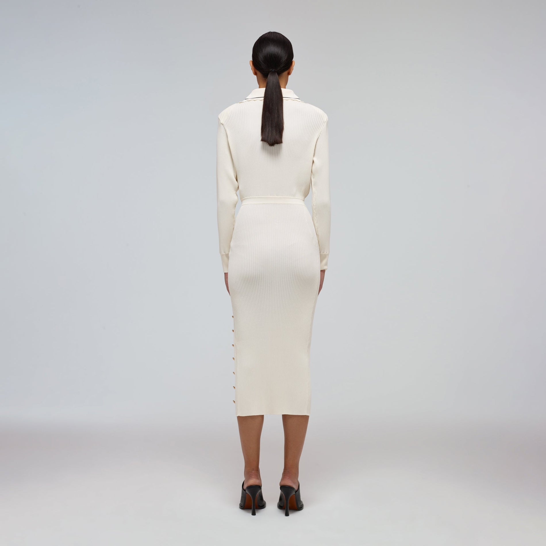 A woman wearing the Ivory Contrast Stitch Ribbed Knit Dress