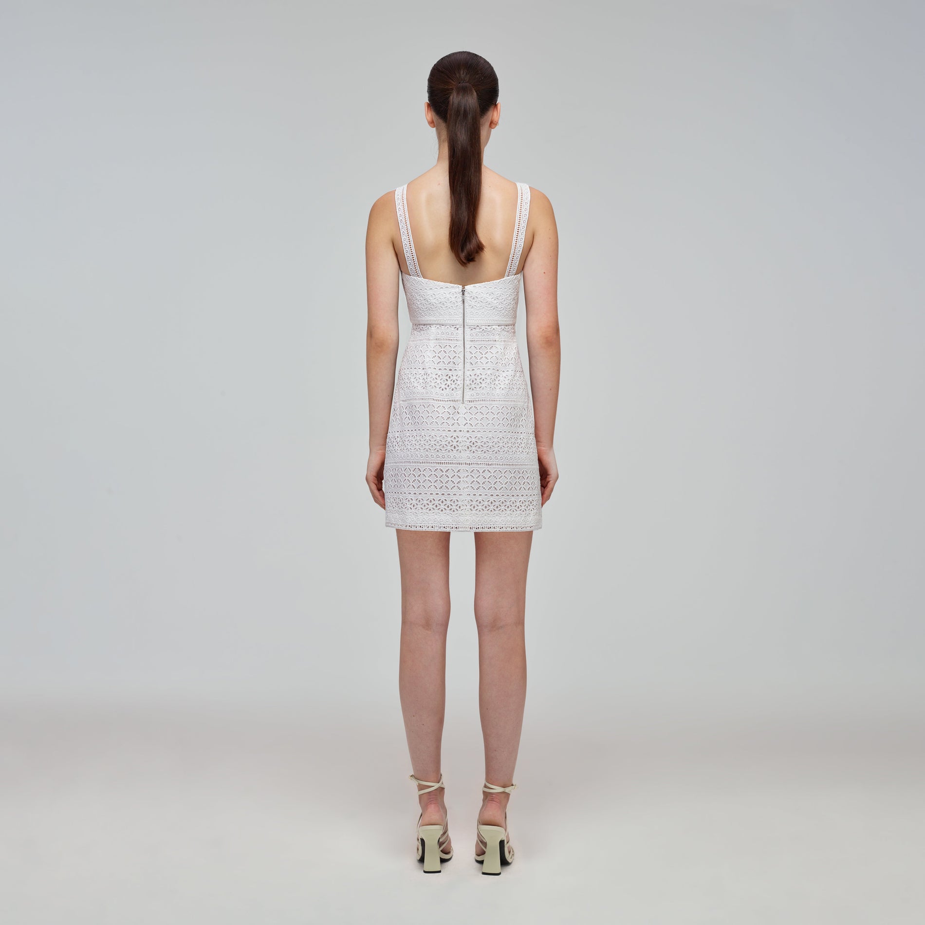 A woman wearing the Mixed Broderie Mini Dress