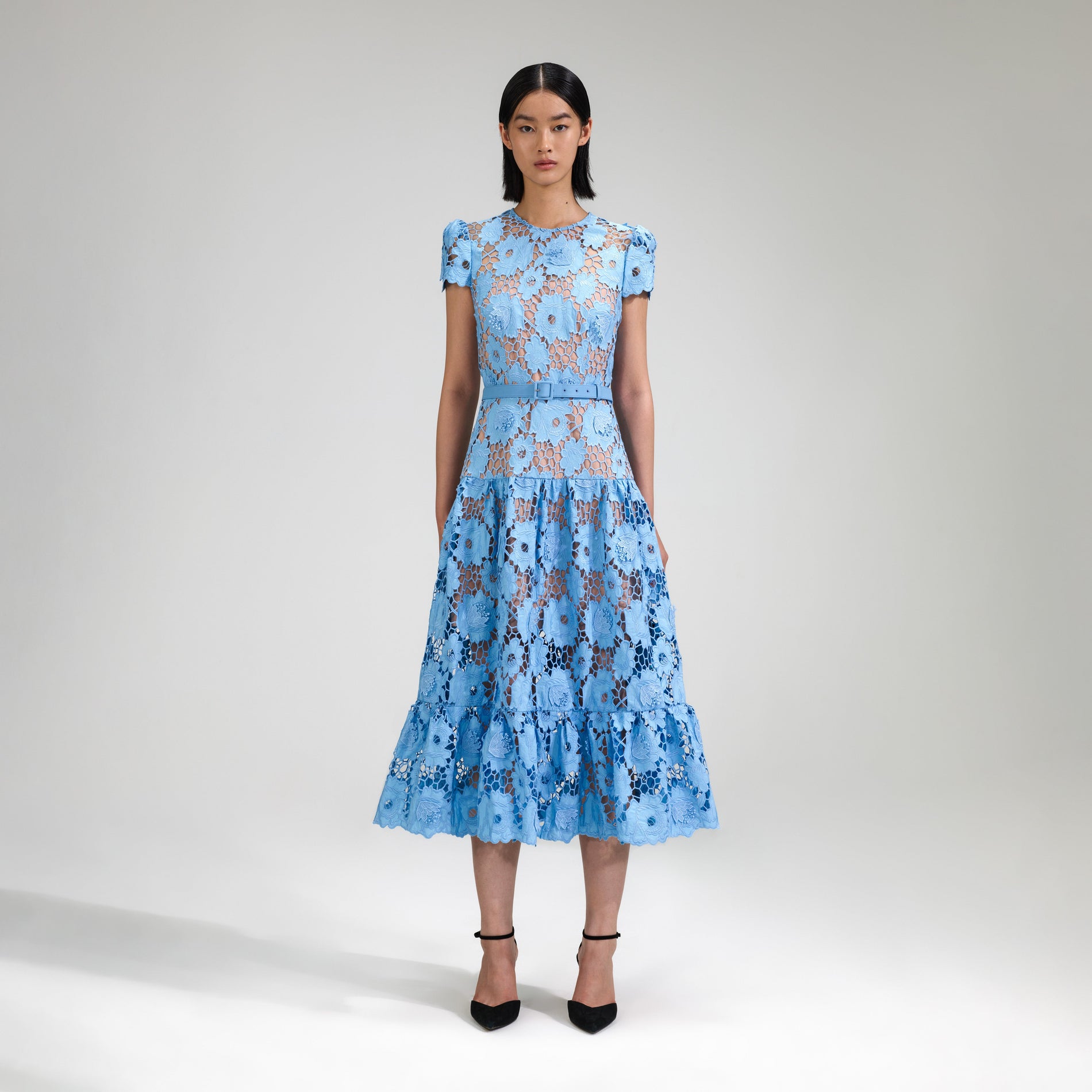 A woman wearing the Blue 3D Cotton Lace Midi Dress