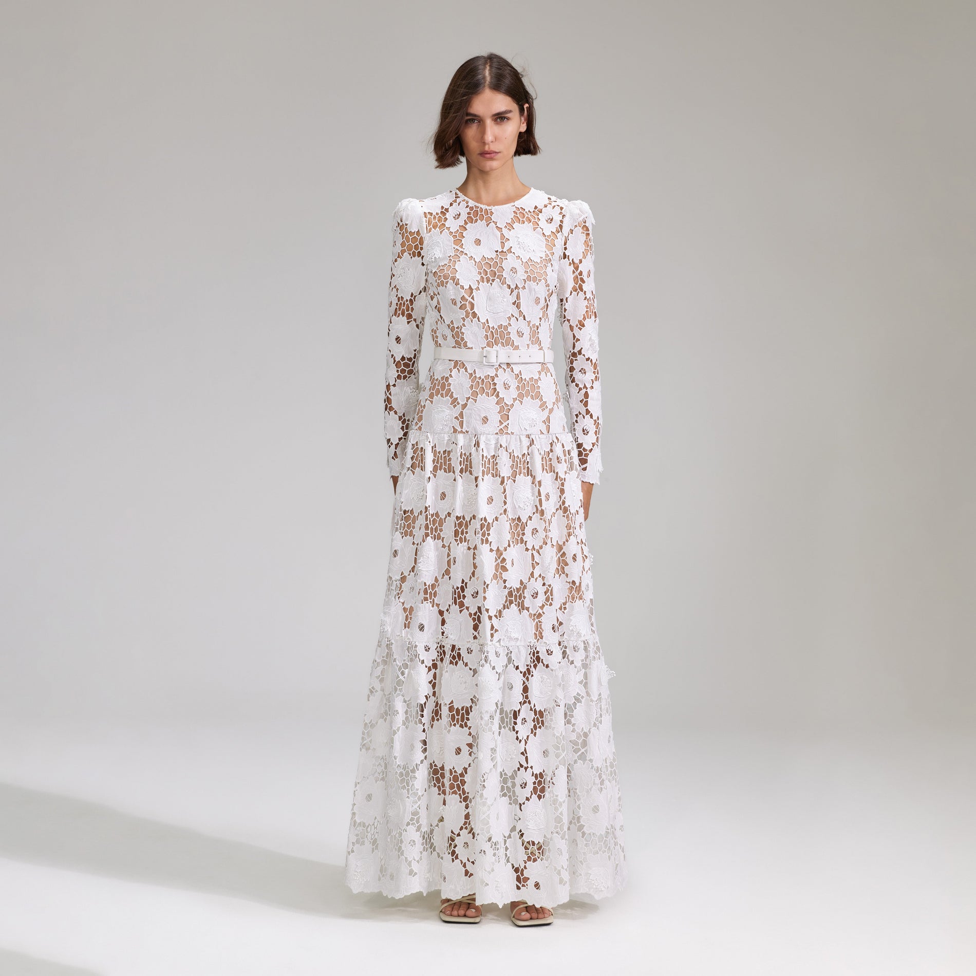 A woman wearing the White 3D Cotton Lace Maxi Dress