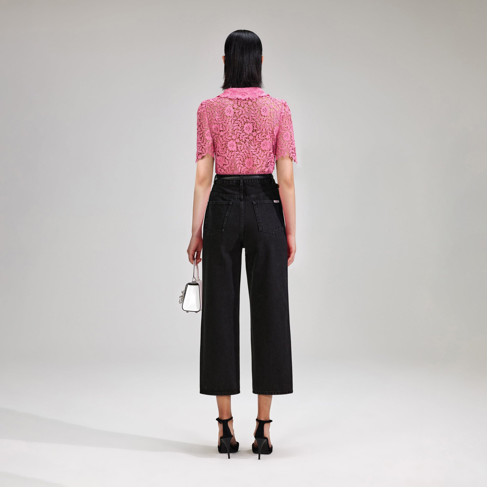 A woman wearing the Pink Rose Lace Top