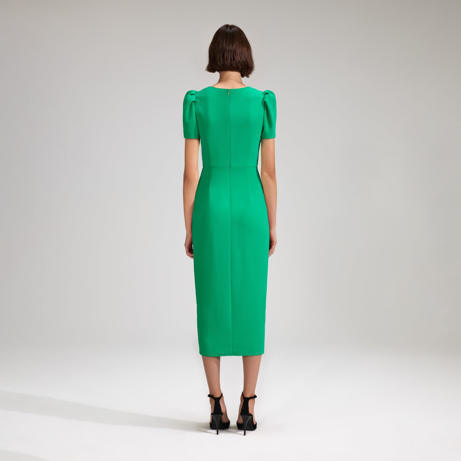 A woman wearing the Green Crepe Midi Dress