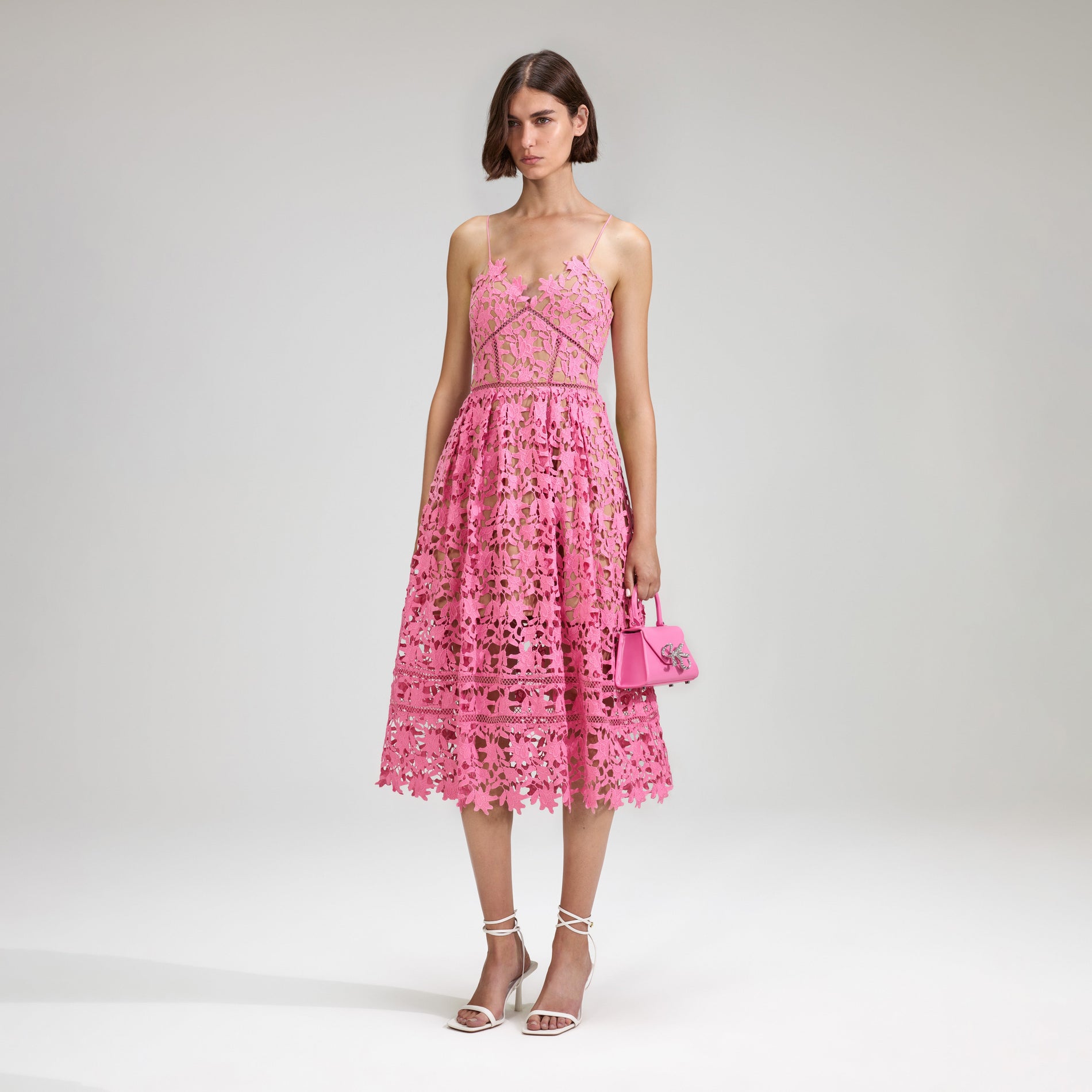 A woman wearing the Pink Azaelea Lace Midi Dress