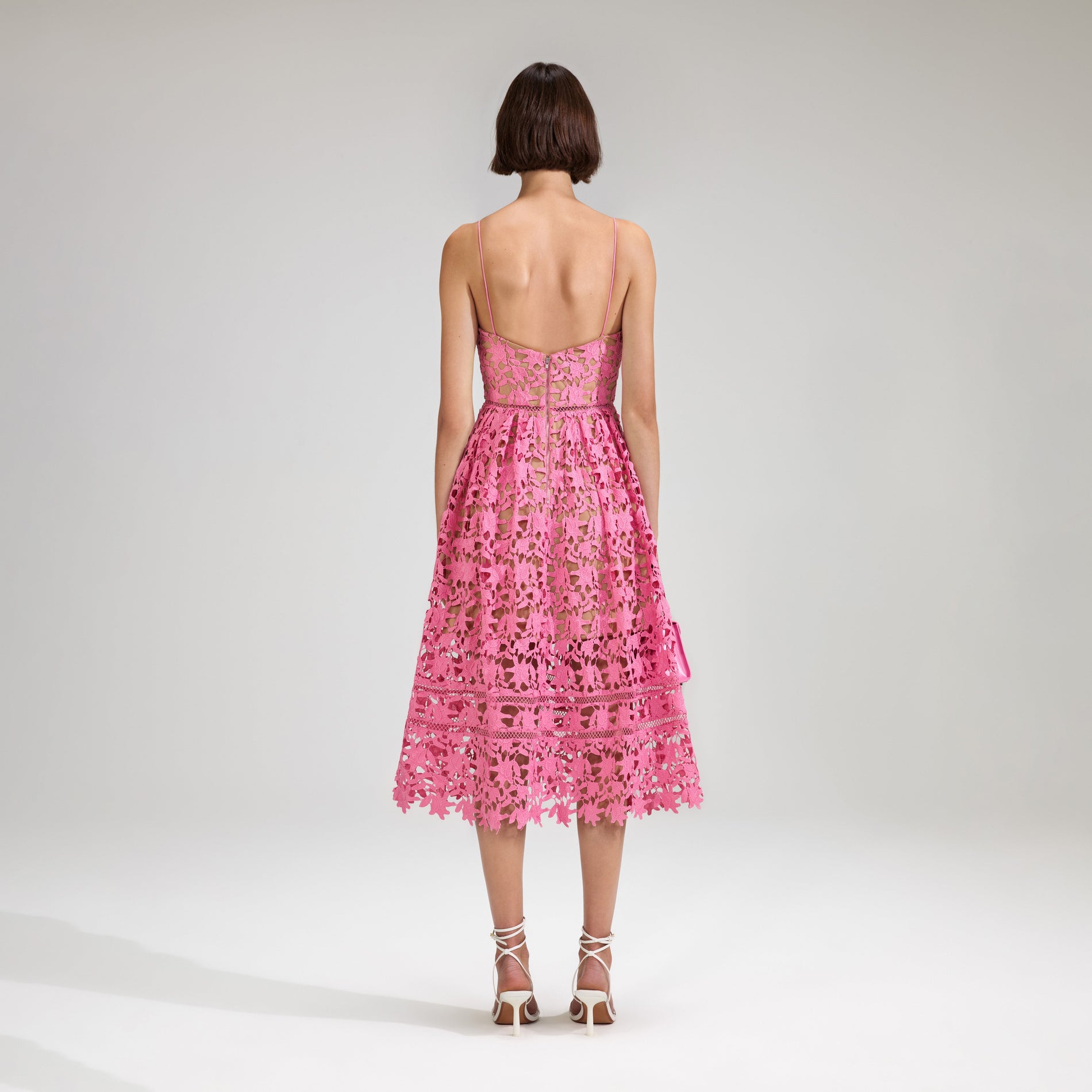 A woman wearing the Pink Azaelea Lace Midi Dress