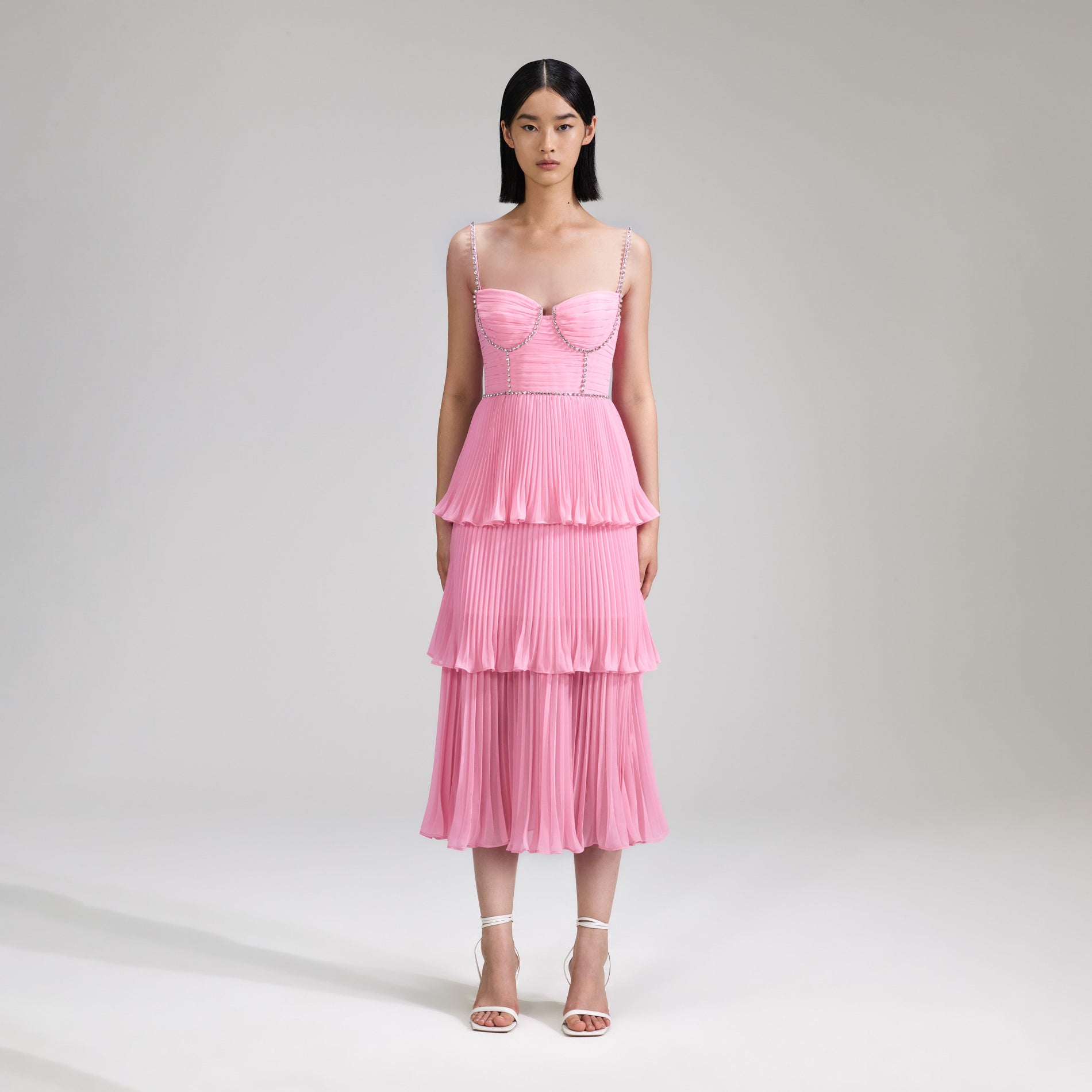 A woman wearing the Pink Chiffon Tiered Midi Dress