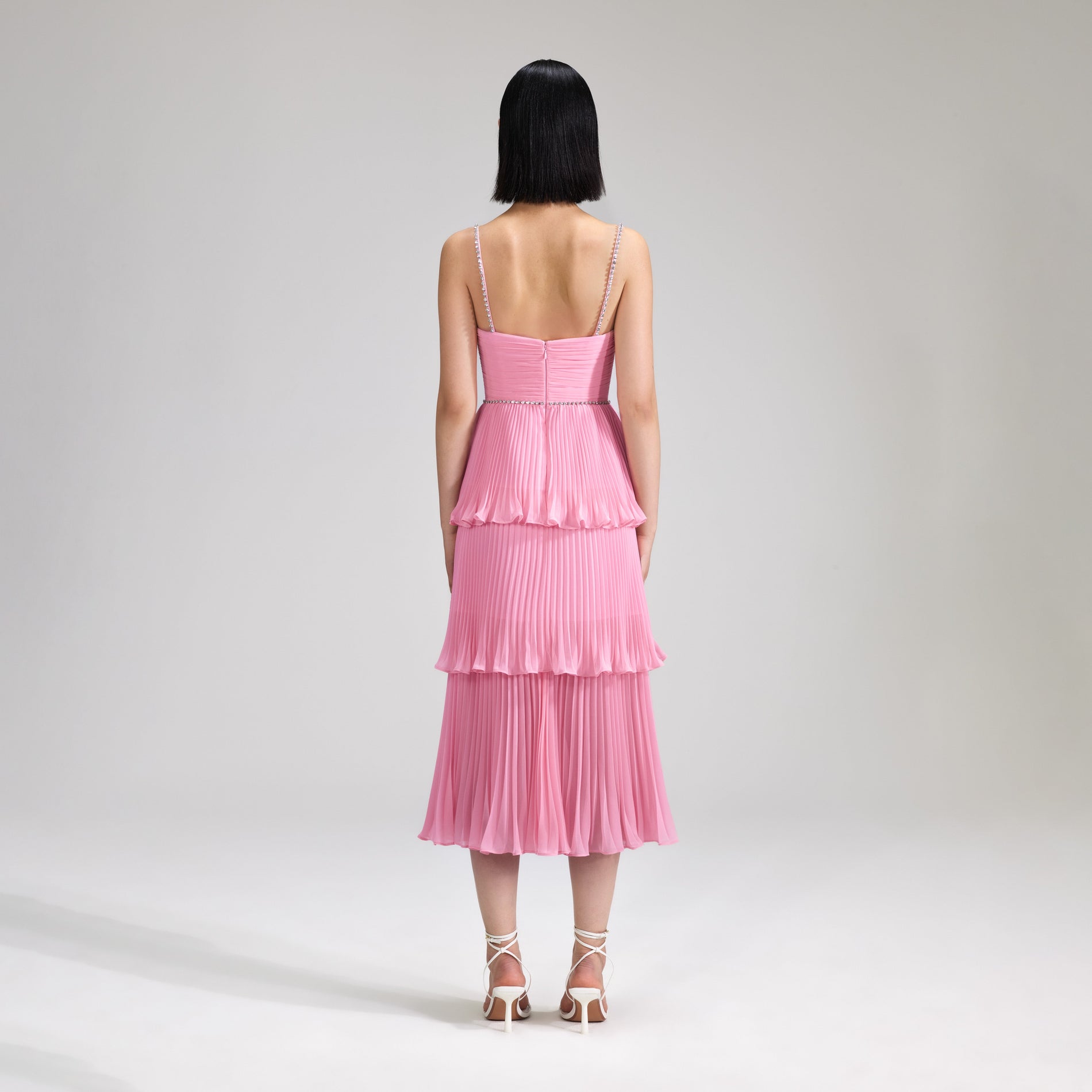 A woman wearing the Pink Chiffon Tiered Midi Dress