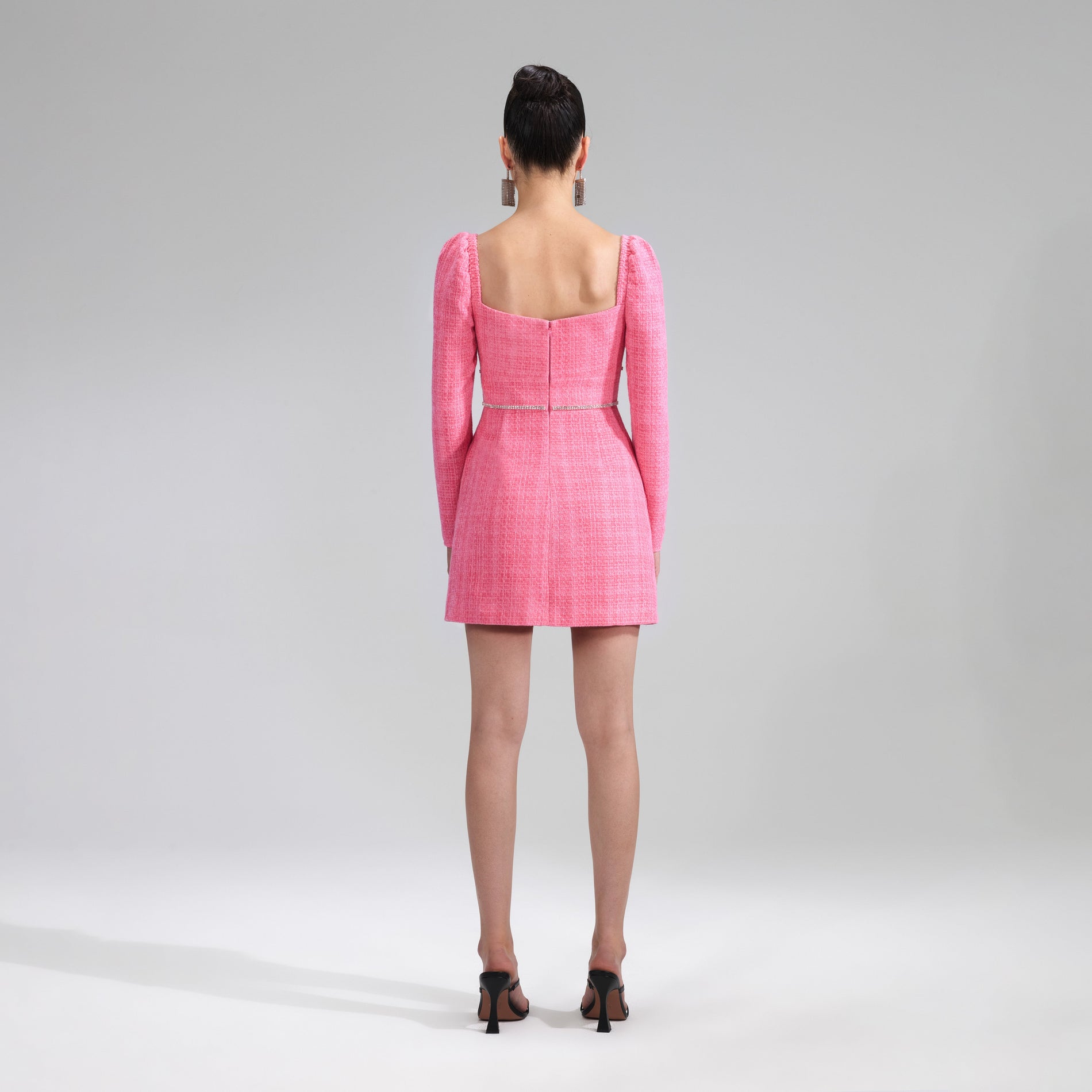 A woman wearing the Pink Boucle Diamante Detail Mini Dress