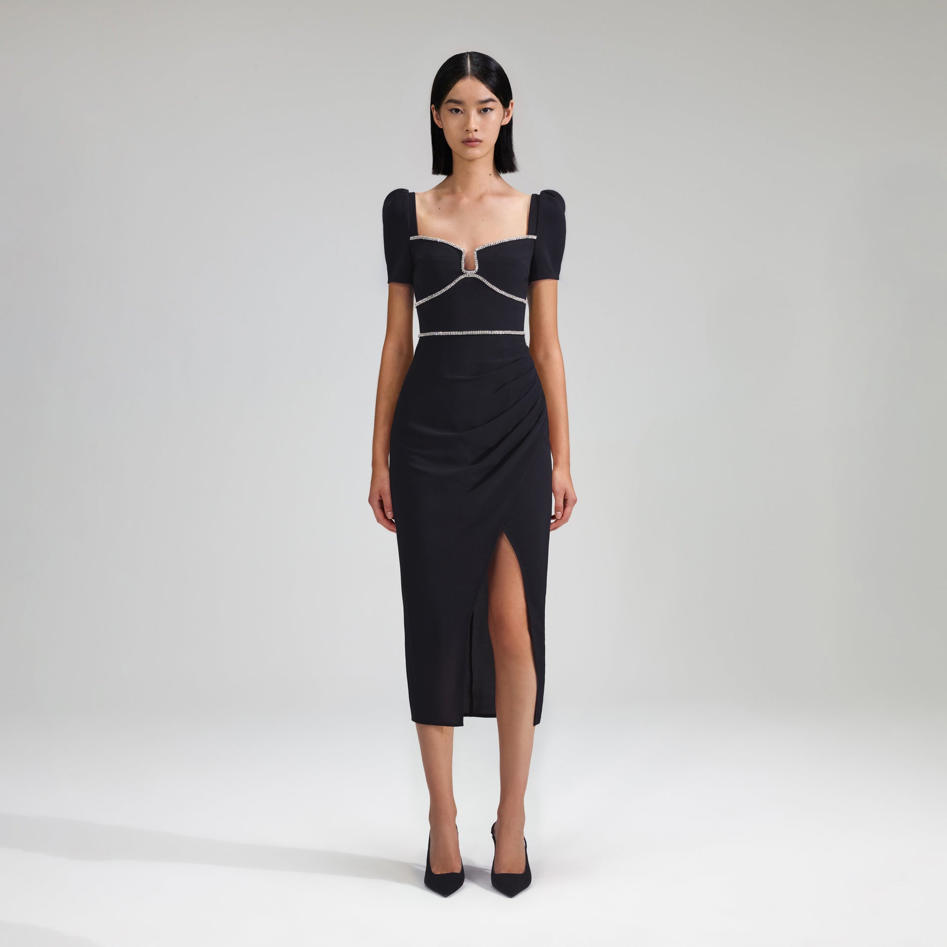 A woman wearing the Black Crepe Diamante Midi Dress