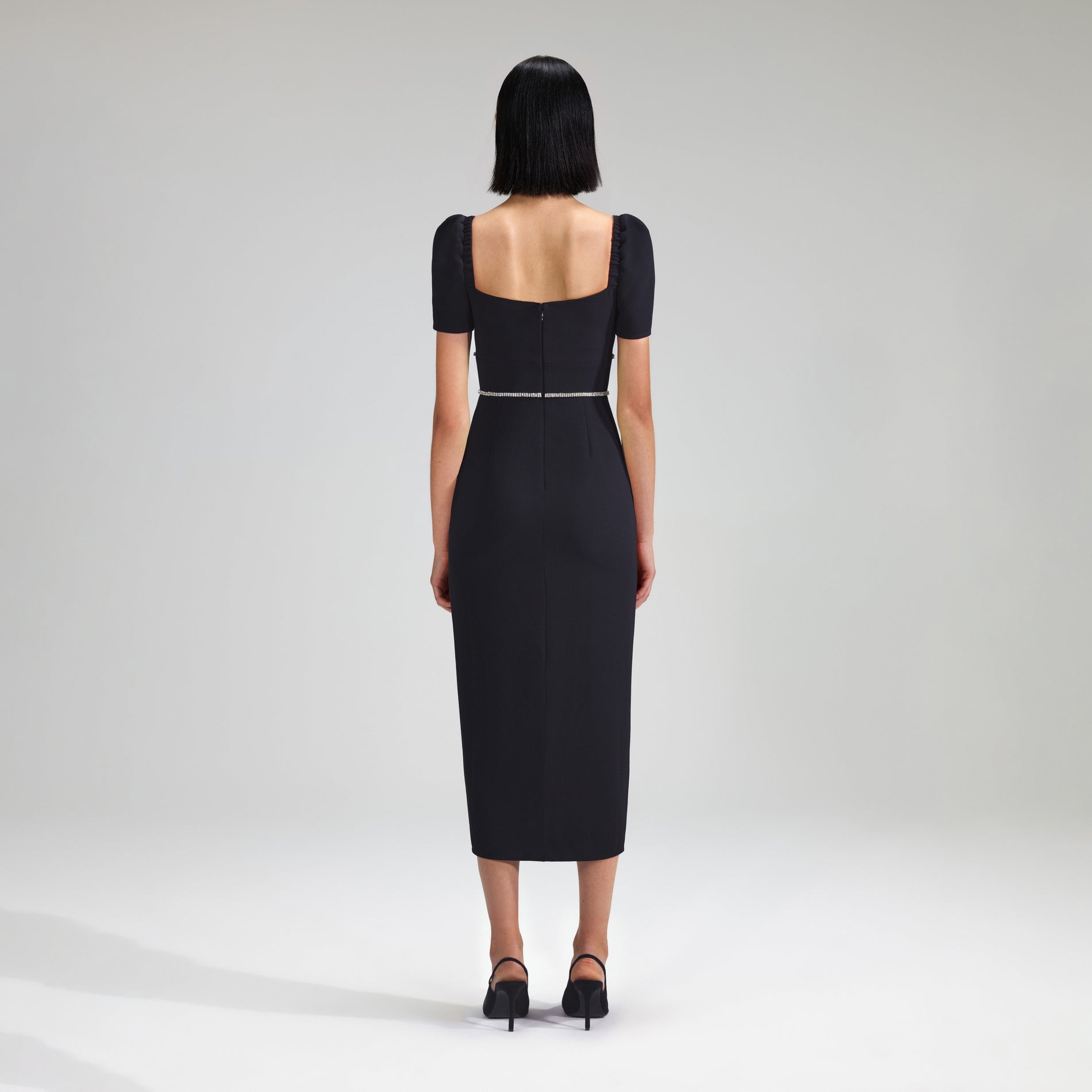 A woman wearing the Black Crepe Diamante Midi Dress