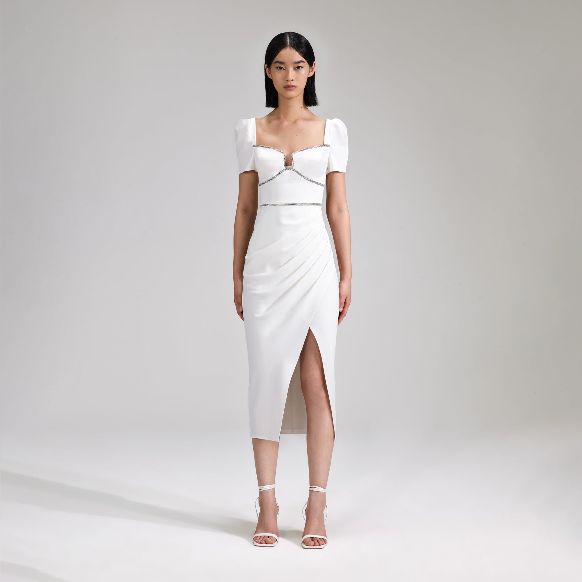 A woman wearing the White Crepe Diamante Midi Dress