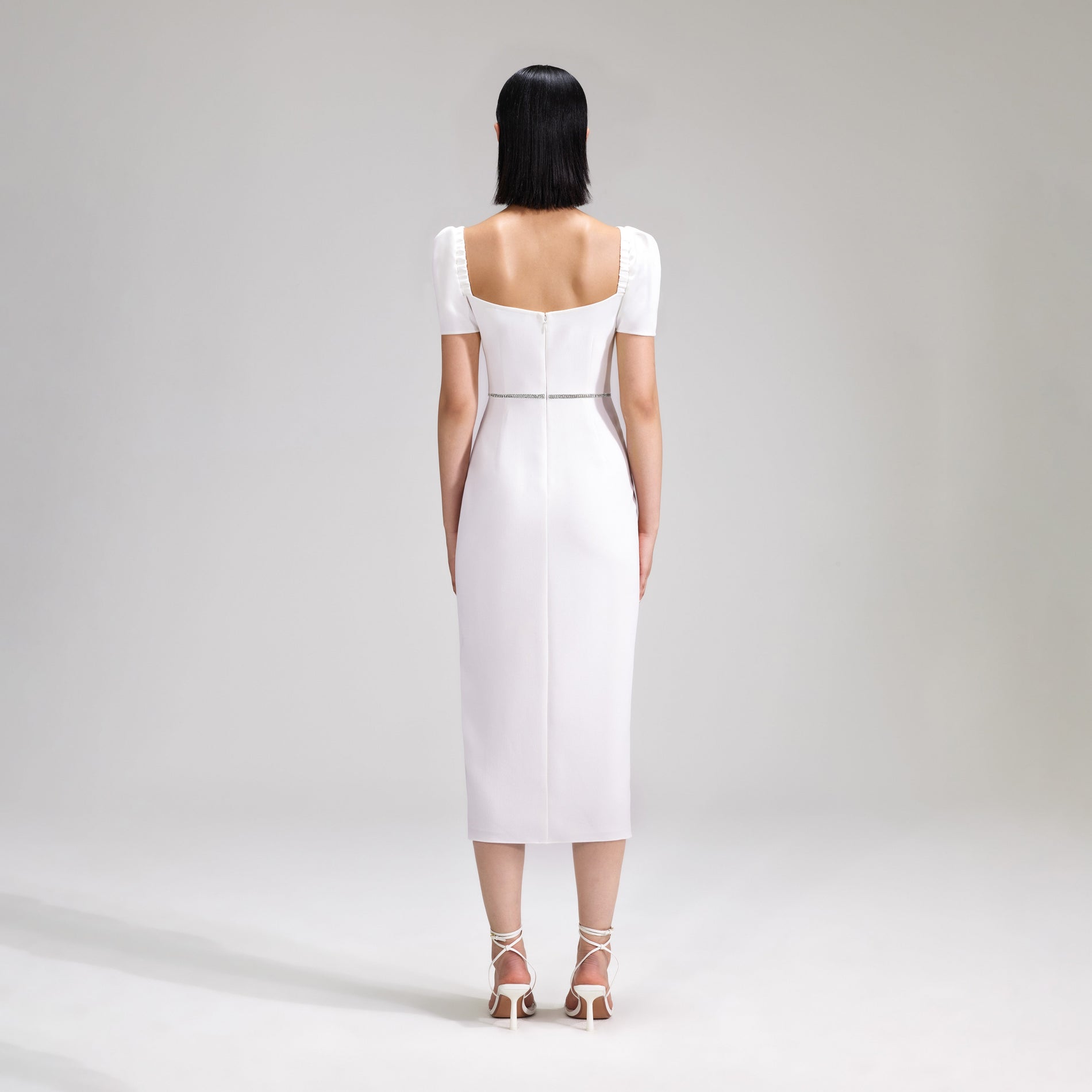 A woman wearing the White Crepe Diamante Midi Dress