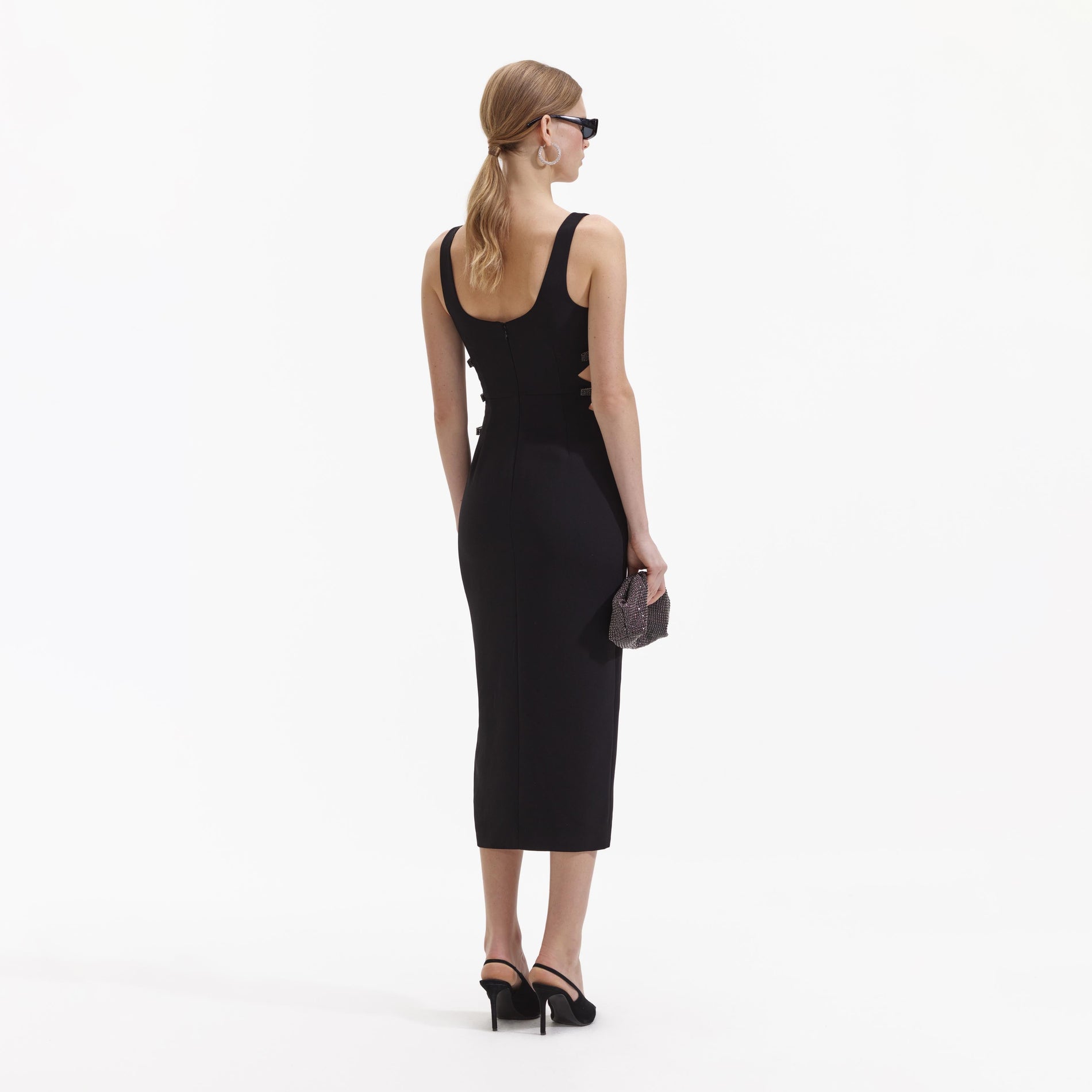 Back view of a woman wearing the Black Crepe Bow Midi Dress