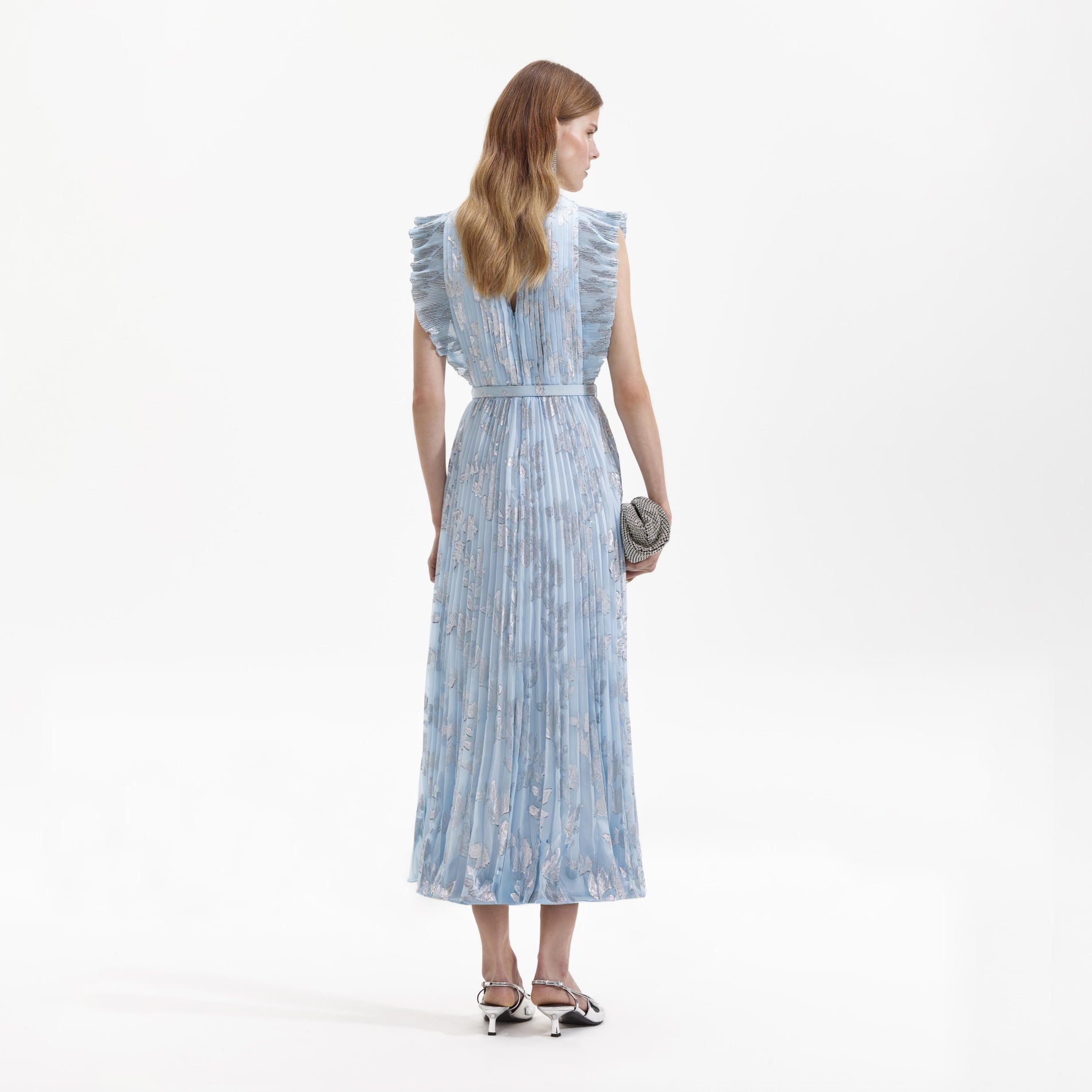 Side view of a woman wearing the Blue Metallic Floral Midi Dress