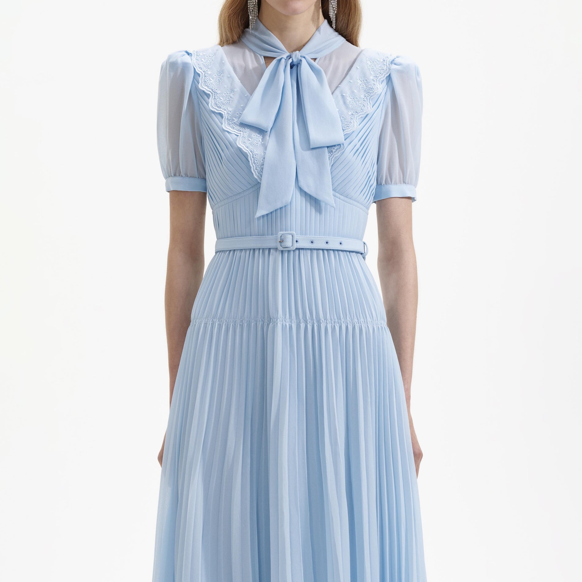 A close up of a woman wearing the Blue Chiffon Bow Midi Dress