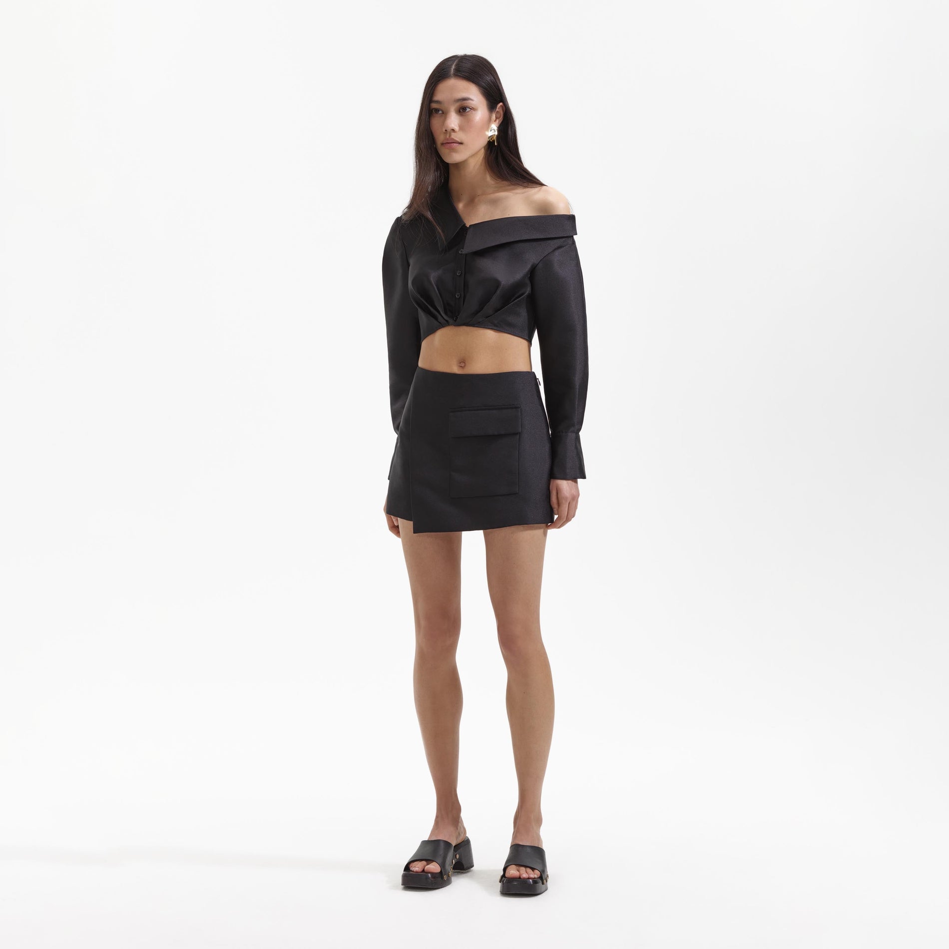Side view of a woman wearing the Black Taffeta Top