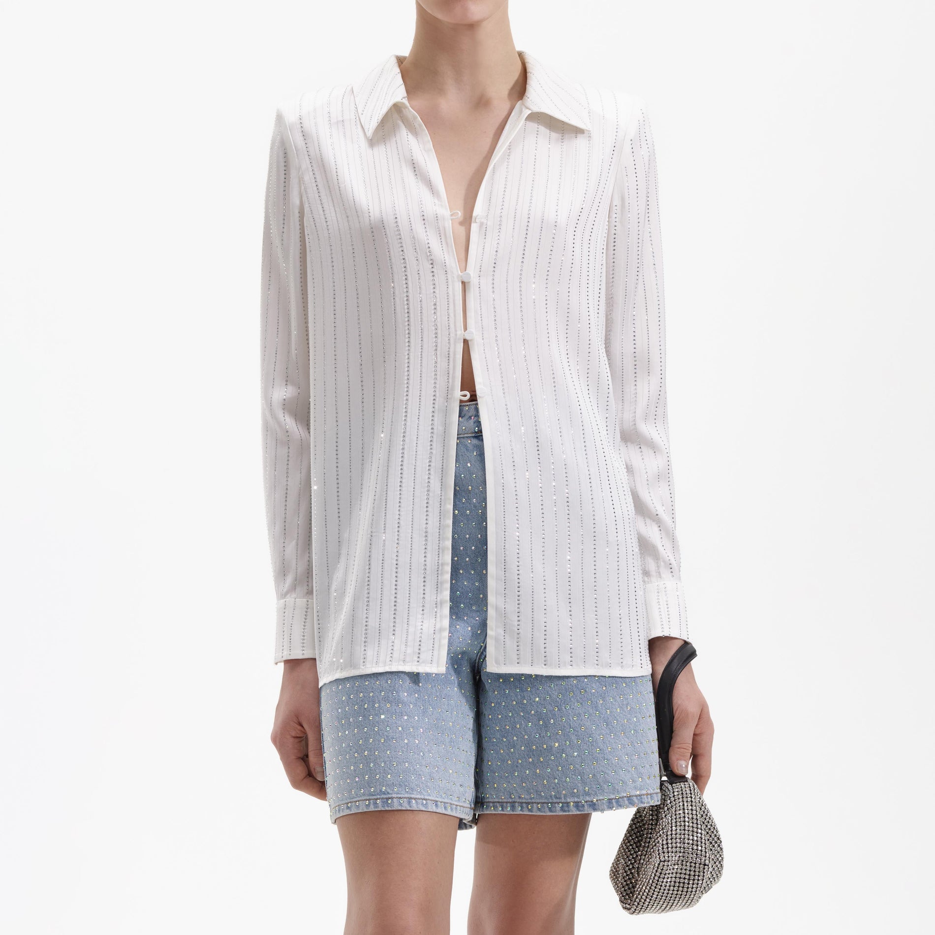 A close up of a woman wearing the White Rhinestone Stripe Shirt