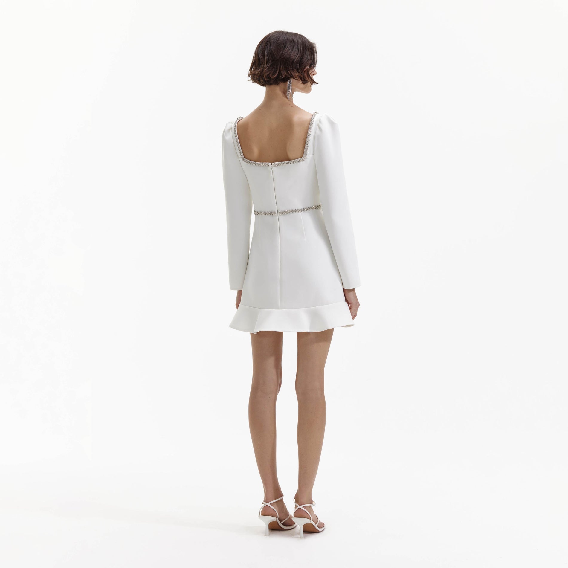 A Woman wearing the White Bonded Crepe Long Sleeve Mini Dress