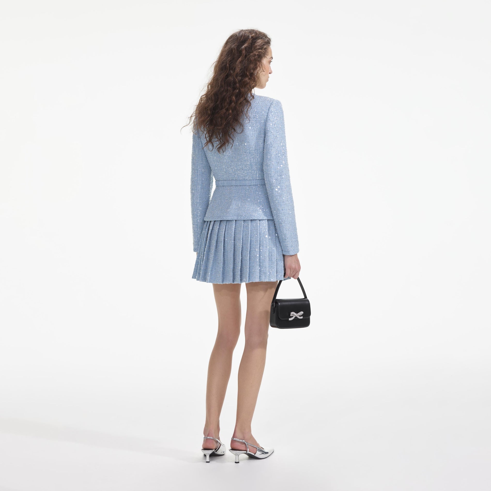 Back view of a woman wearing the Blue Sequin Boucle Mini Jacket Dress