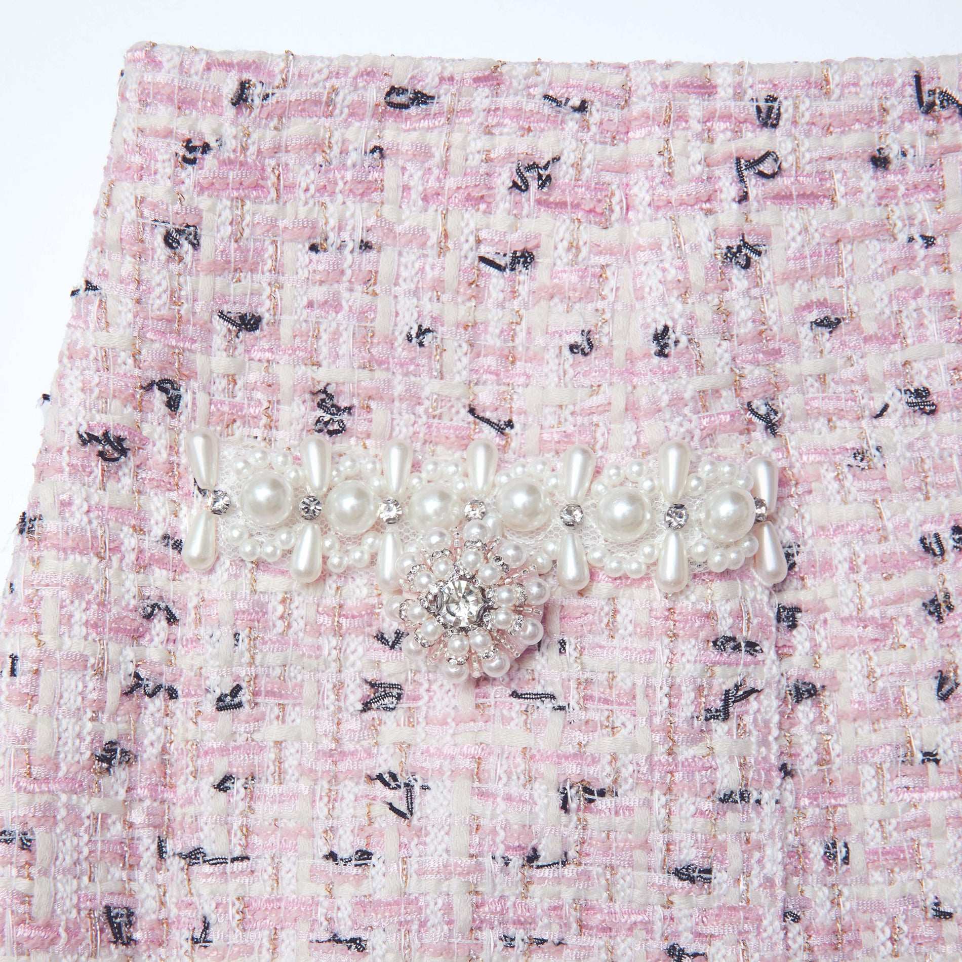 Side view of a woman wearing the Pink Boucle Pearl Midi Skirt