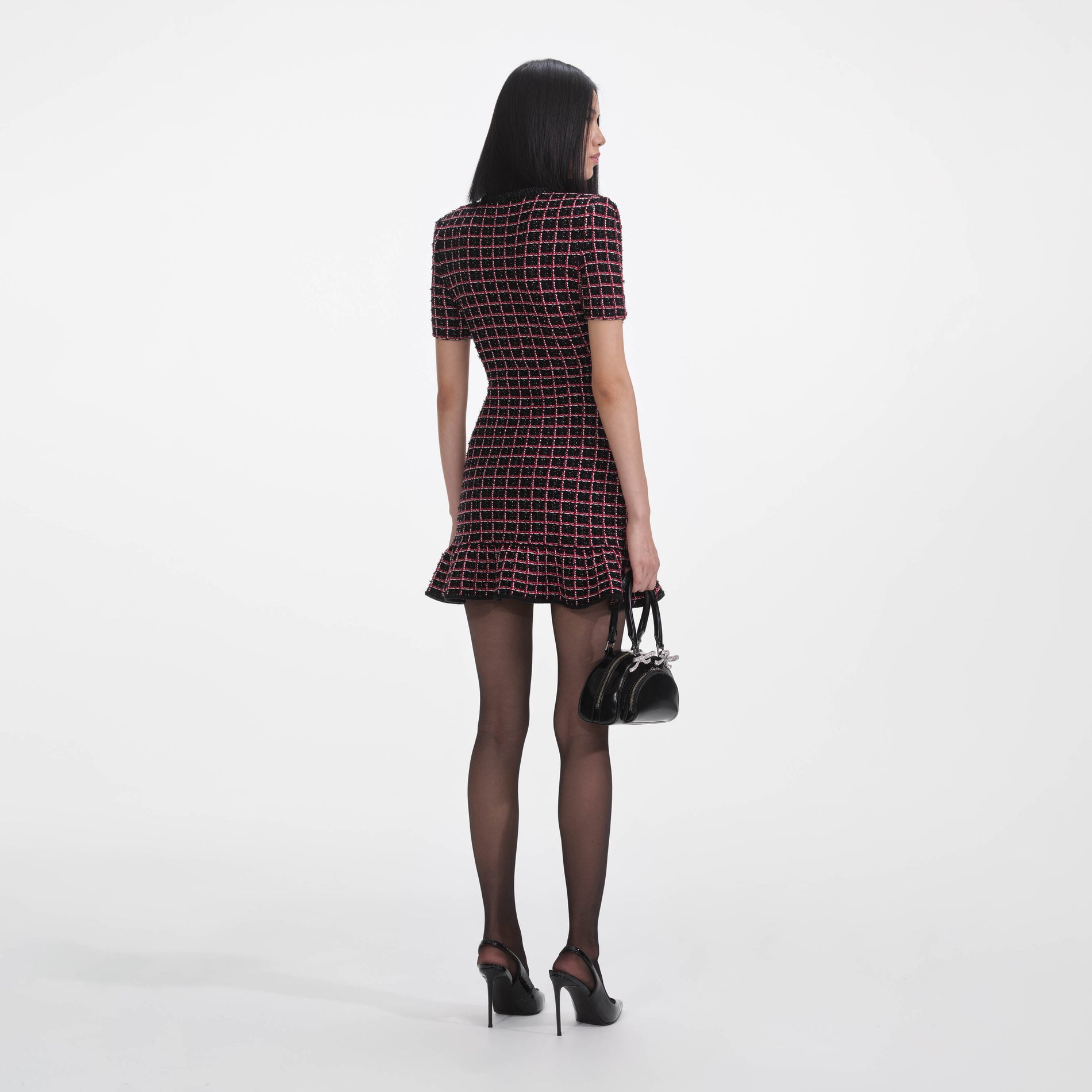 Back view of a woman wearing the Black And Red Check Knit Mini Dress